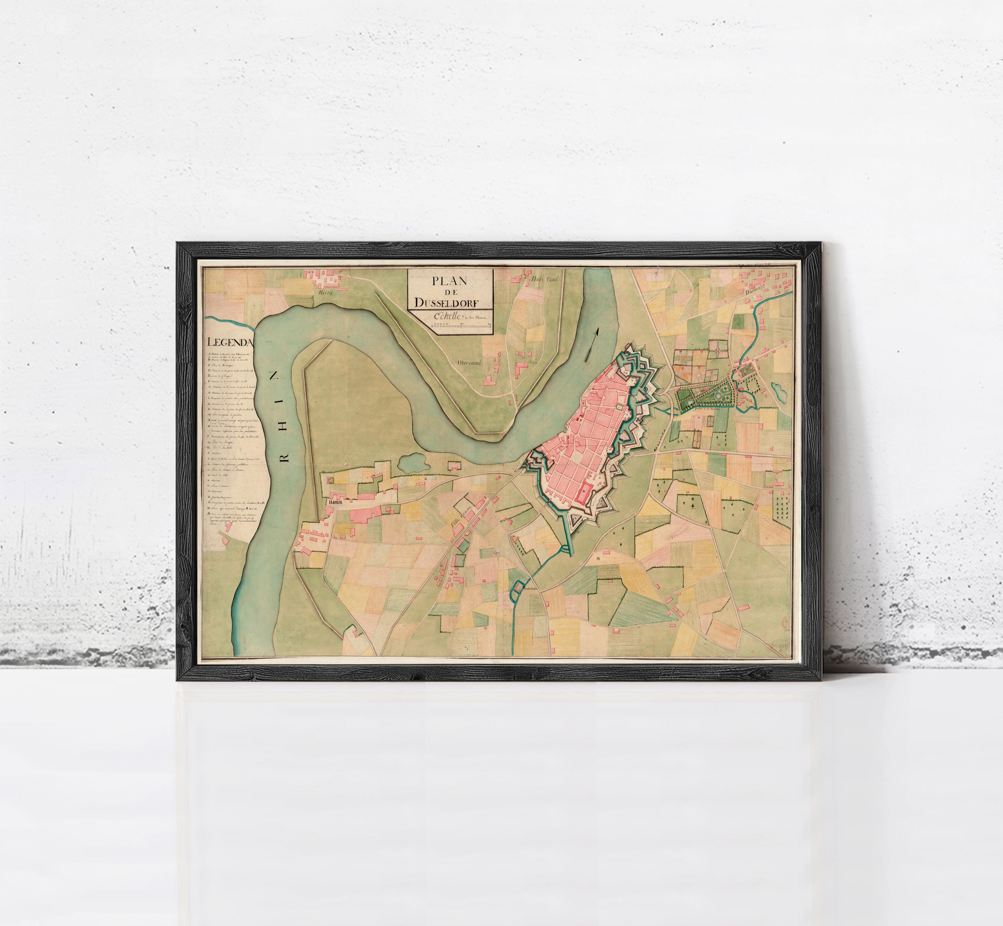 The image is a framed map of a city, depicting various landmarks and geographical features.