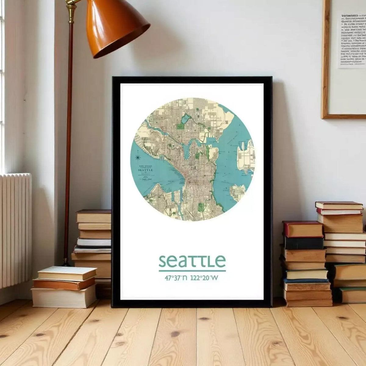 A framed map of Seattle, Washington, with a light brown lamp and a stack of books in the background.