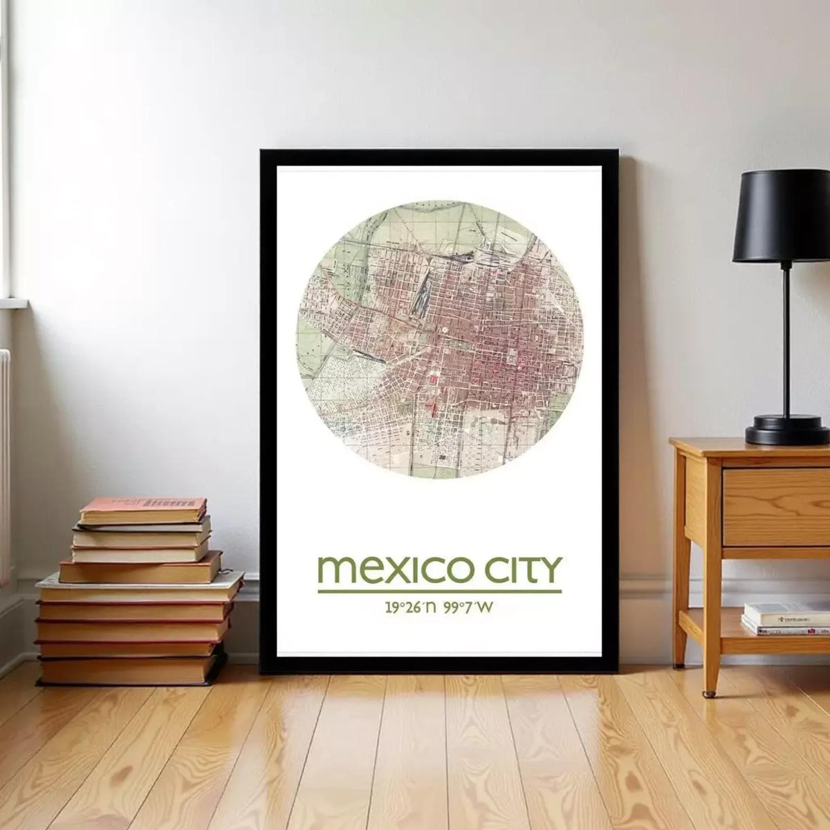 A framed map of Mexico City is displayed on a wall, with a stack of books and a wooden side table nearby.