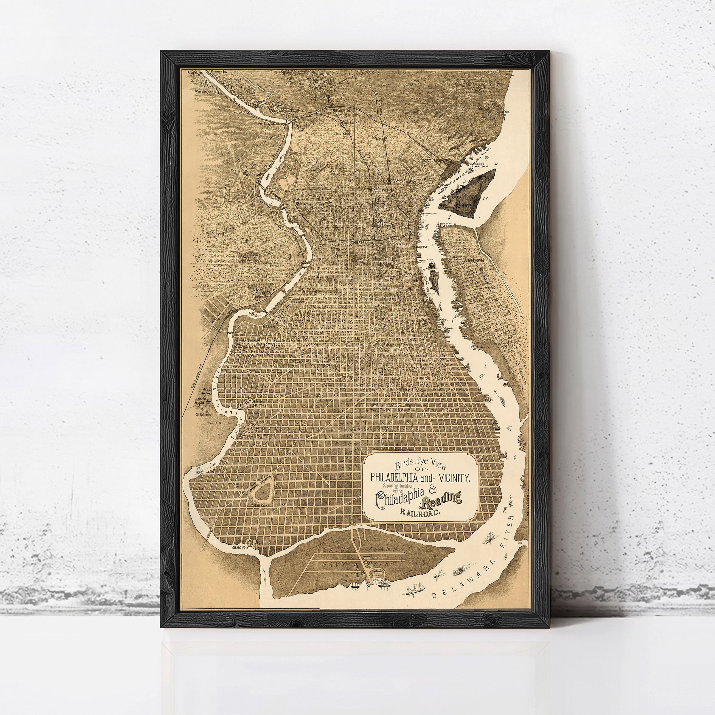The image is a framed vintage map of Philadelphia, Pennsylvania, depicting the city's layout and surrounding areas.