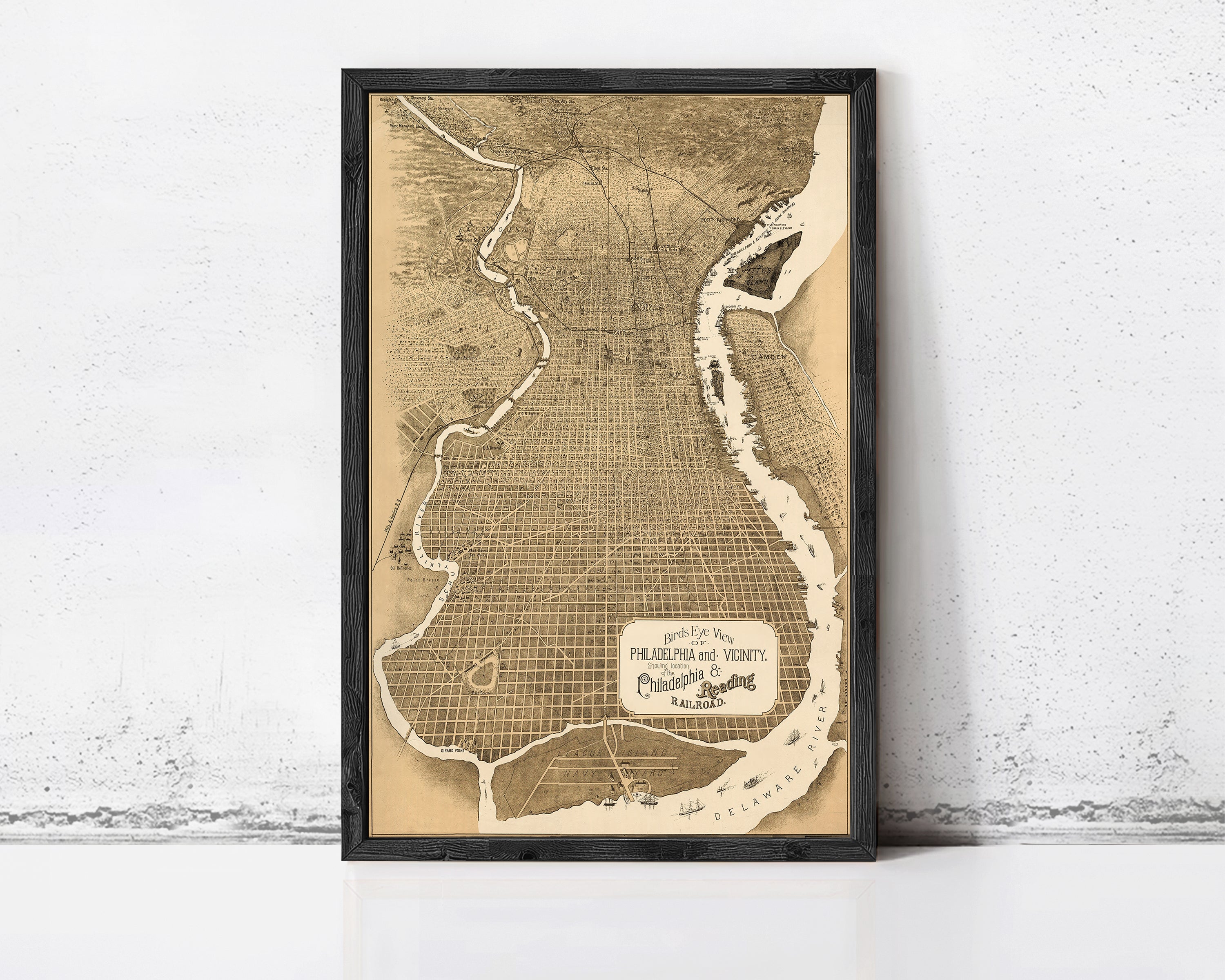 The image is a framed vintage map of Philadelphia, Pennsylvania, depicting the city's layout and surrounding areas.