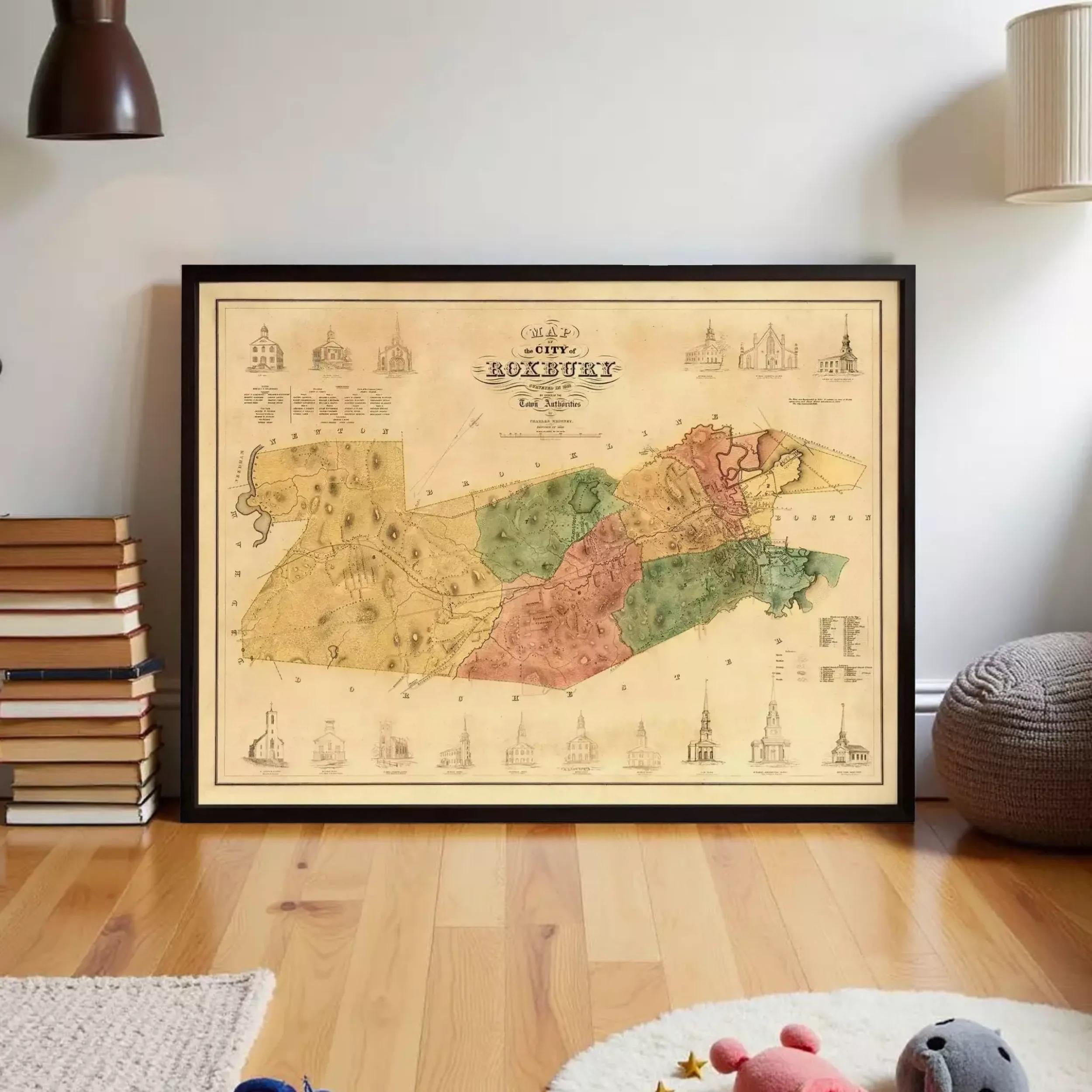 a framed map of the city of Roxbury, Massachusetts, with various landmarks and buildings depicted on it.