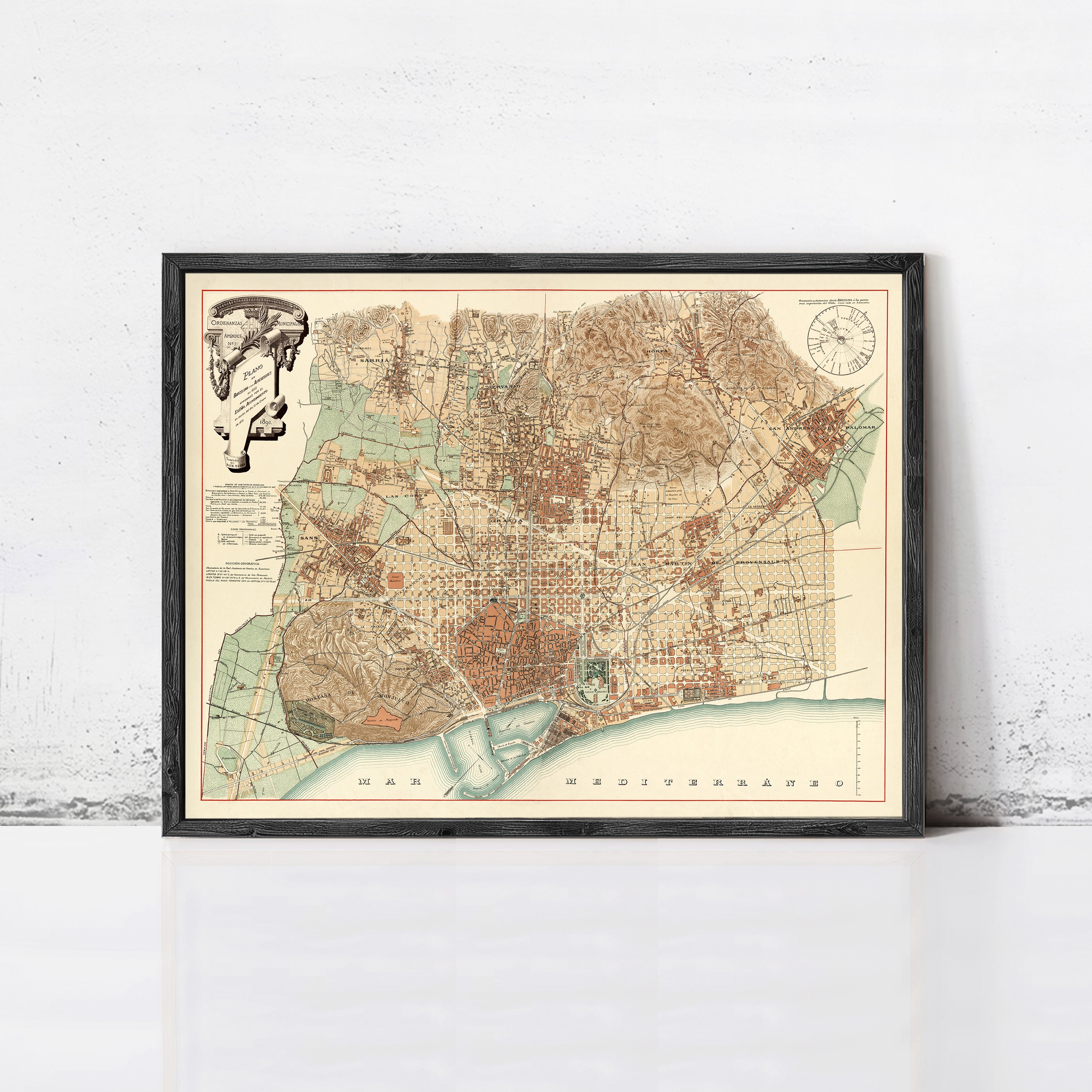 The image is a framed vintage map of Barcelona, Spain, depicting the city's streets, landmarks, and surrounding areas.