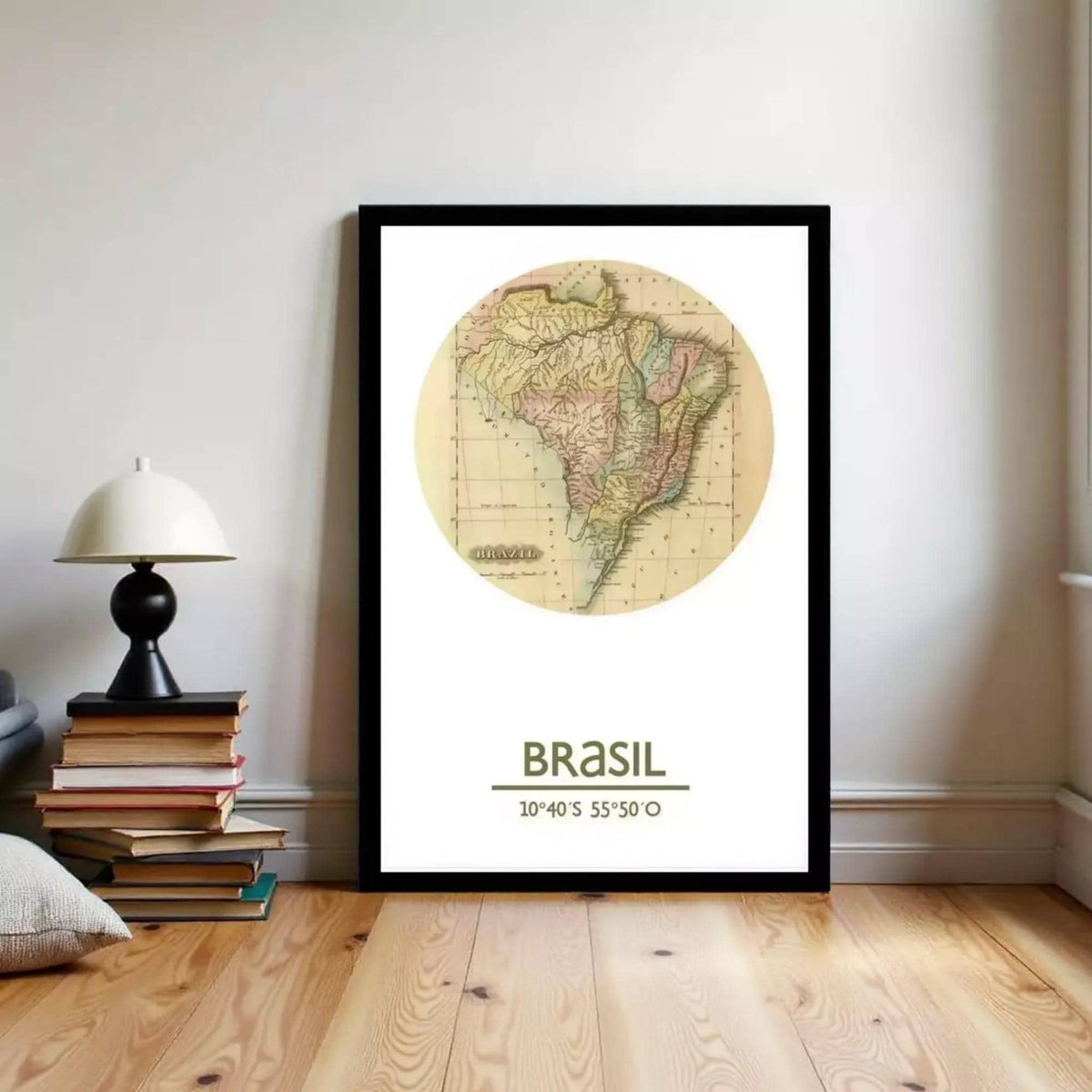 A framed map of Brazil is displayed on a wall, with a stack of books and a lamp to the left.