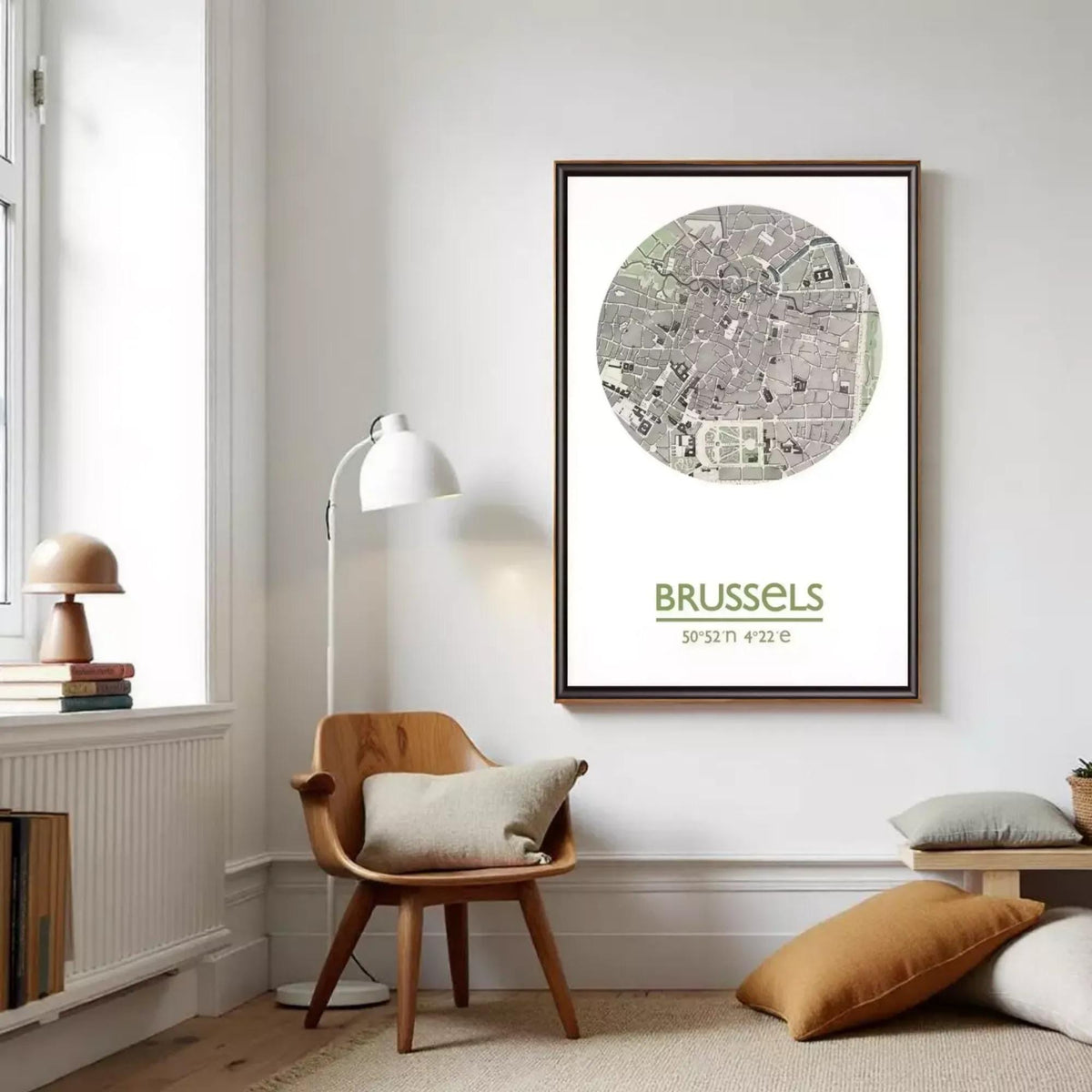 a living room with a wooden chair, a lamp, and a framed map of Brussels hanging on the wall.