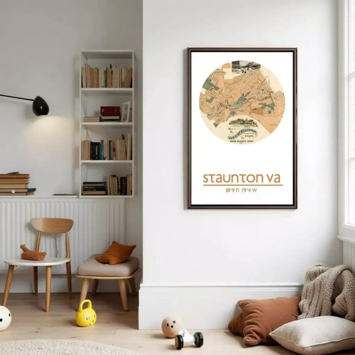 a cozy living room with a bookshelf, a chair, a small table, and a child's toy. A framed map of Staunton, Virginia is hanging on the wall, and there is a small stuffed animal on the floor.