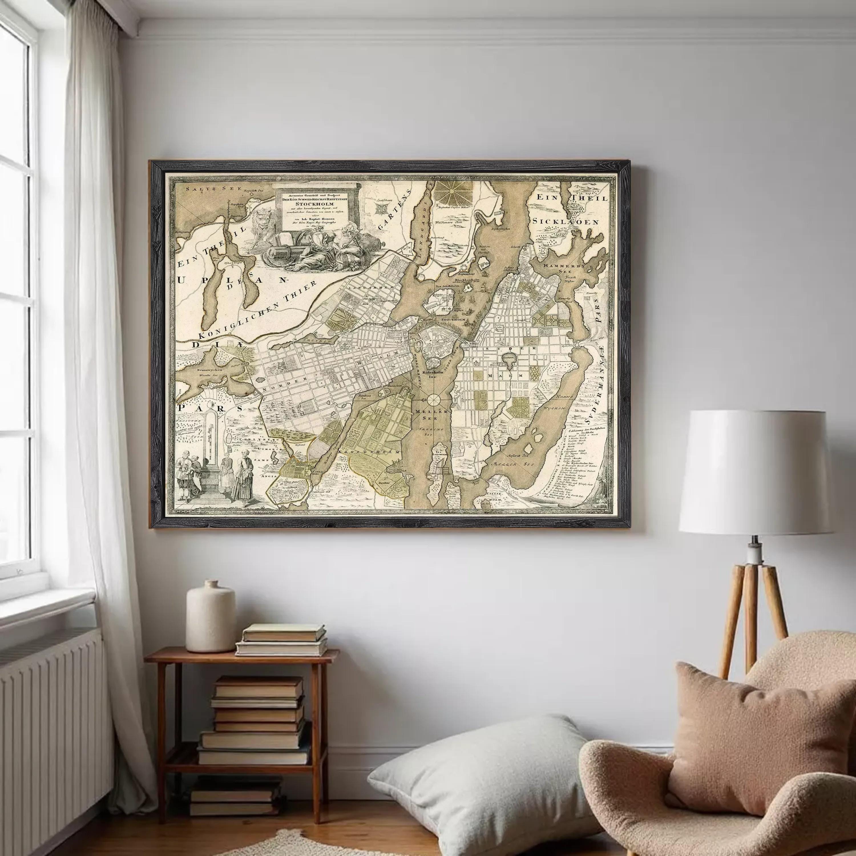 The image is a framed antique map of a city, likely from the 18th century, with detailed cartography and illustrations.