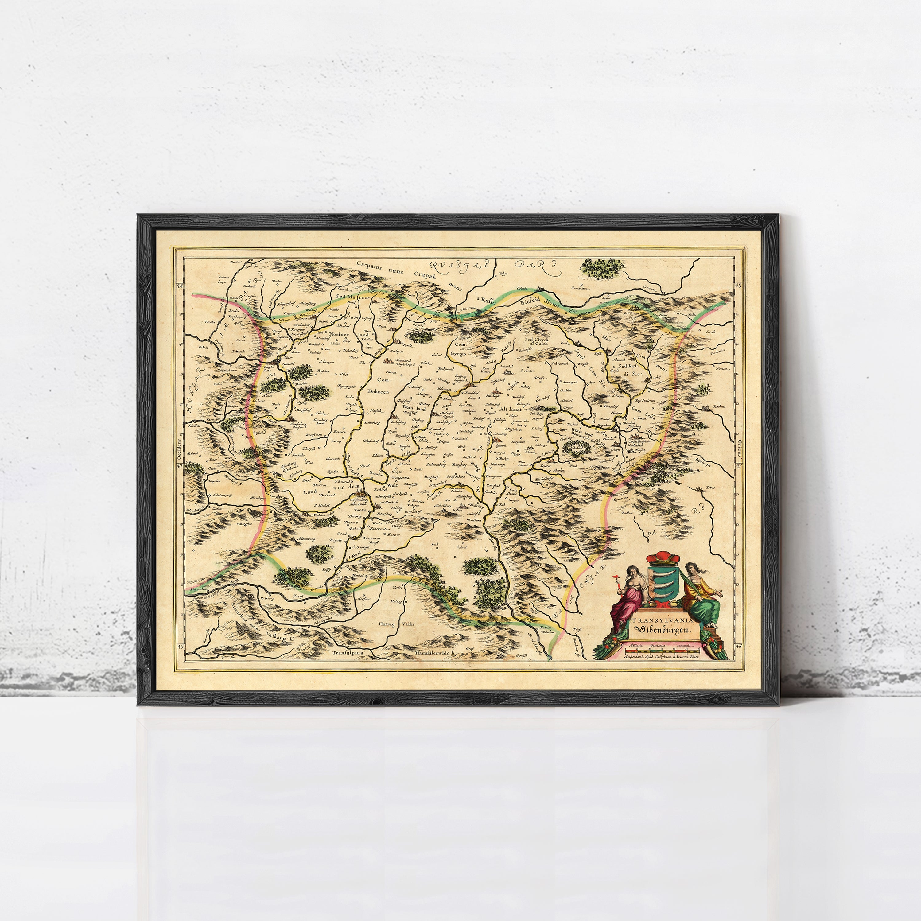 The image is a framed antique map of a region, likely from the 16th century, with detailed geographical markings and illustrations.