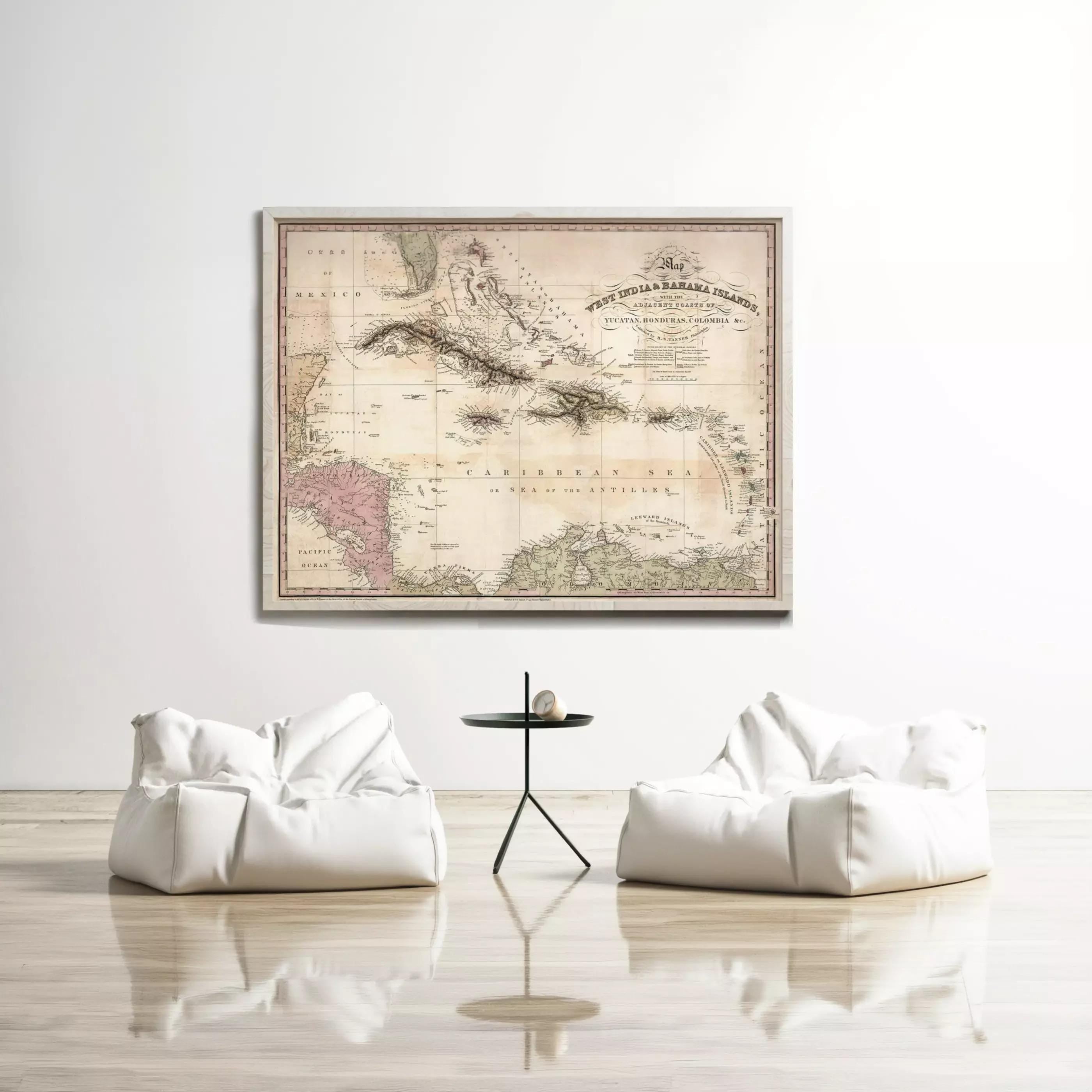 a large antique map of the Caribbean Sea hanging on a white wall, with two white bean bag chairs positioned in front of it.