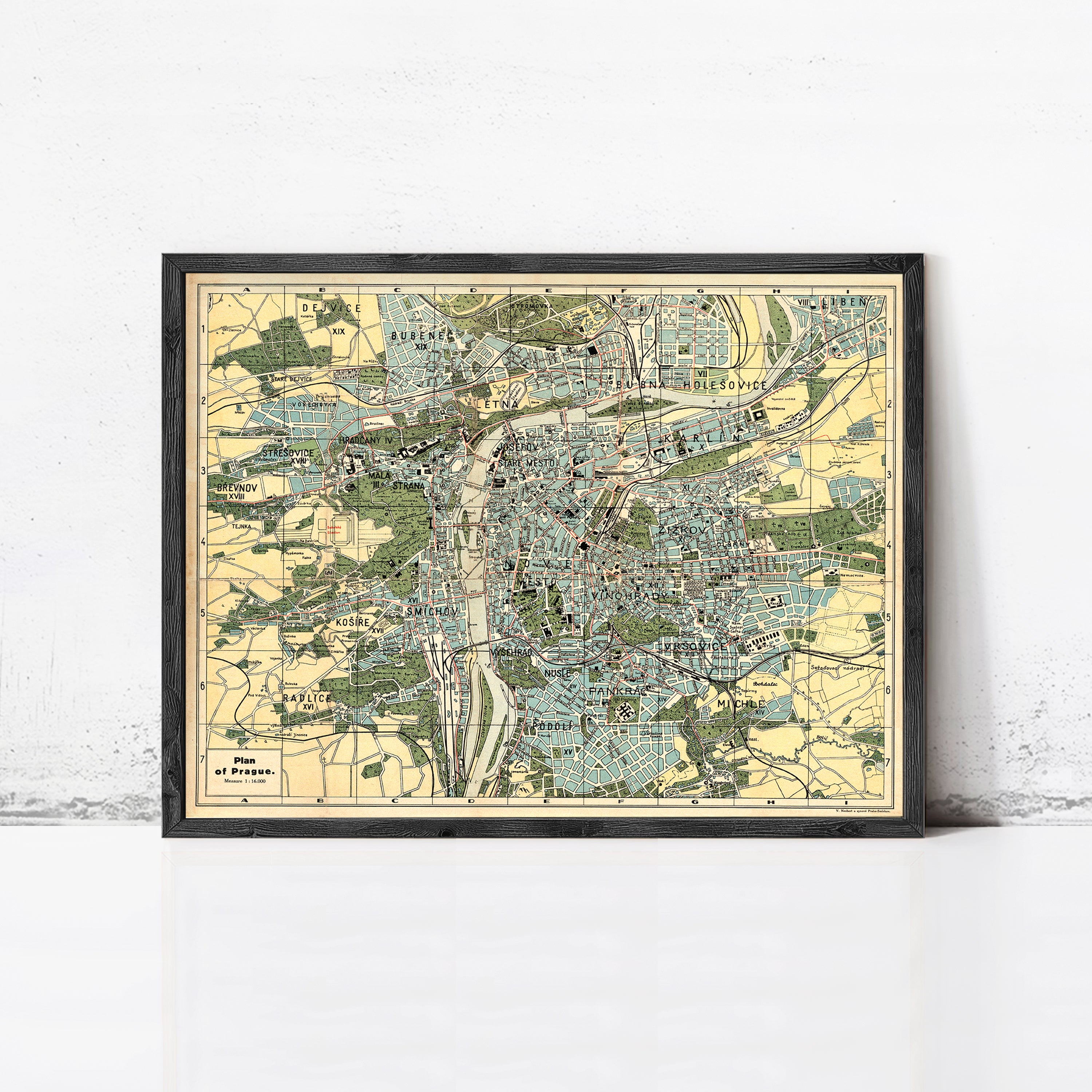 The image is a framed vintage map of a city, likely Paris, with various streets, landmarks, and geographical features depicted.