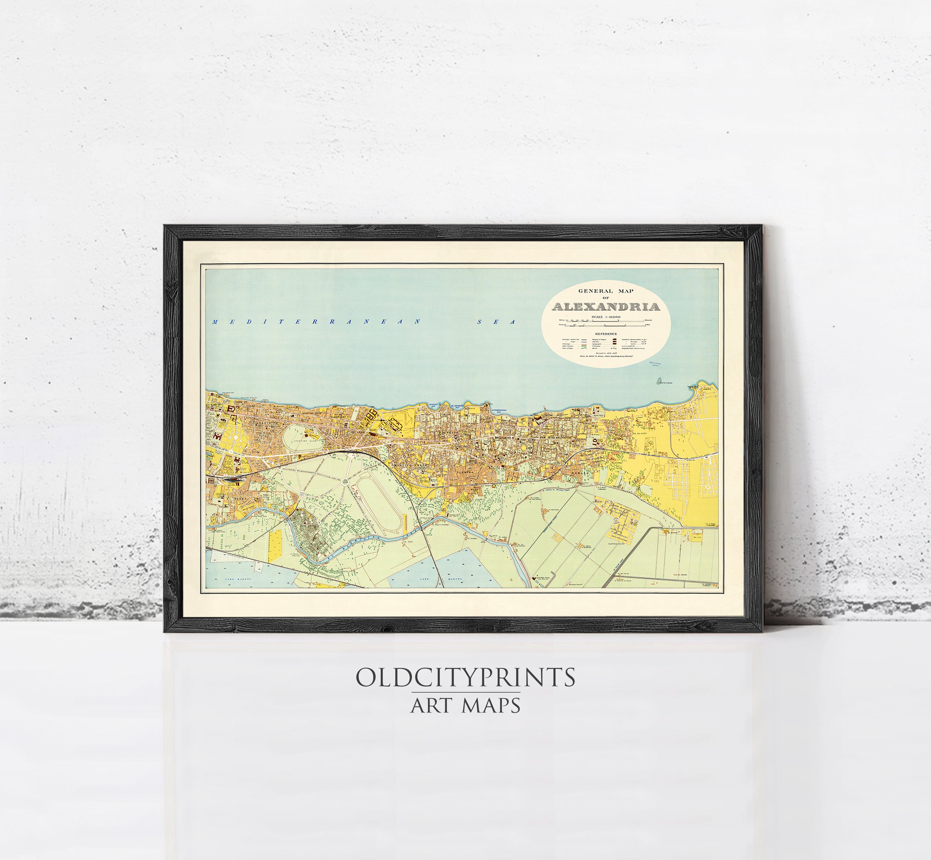 The image is a framed vintage map of the city of Alexandria, depicting the city's layout and surrounding areas.