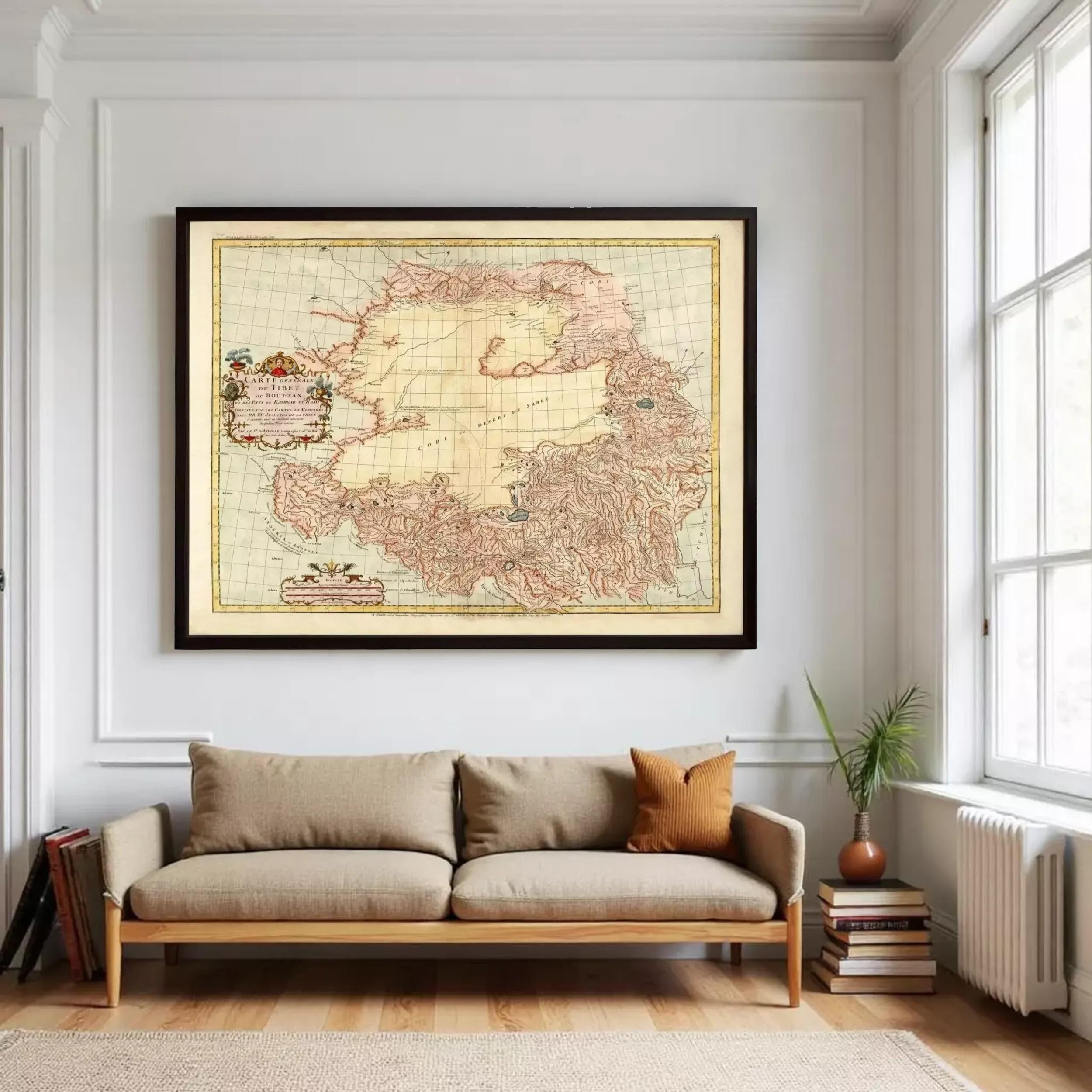 a large framed map of the Arctic region hanging on a white wall above a beige sofa in a cozy living room setting.