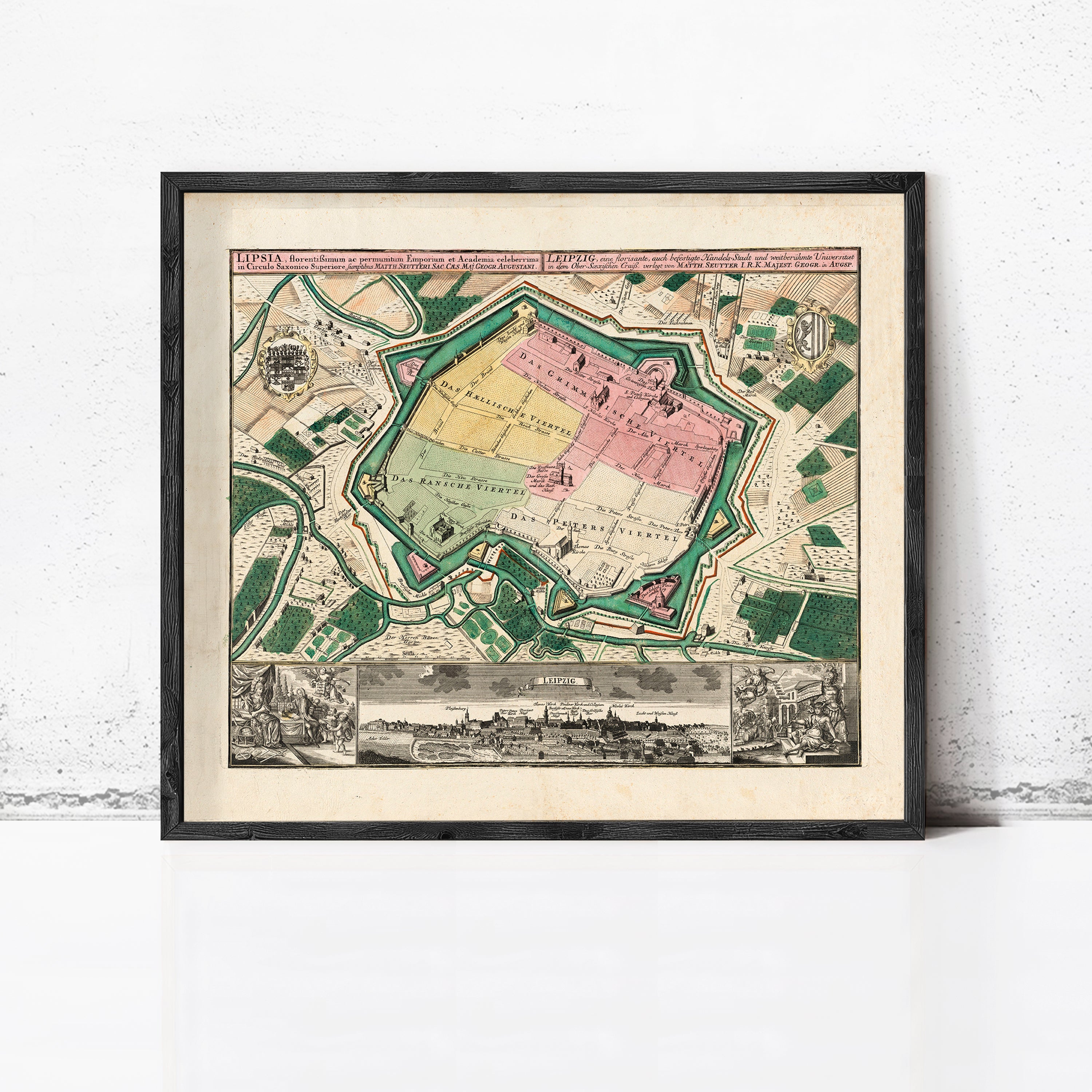 The image is a framed vintage map of a city, depicting a detailed layout of the city's streets, buildings, and other landmarks.