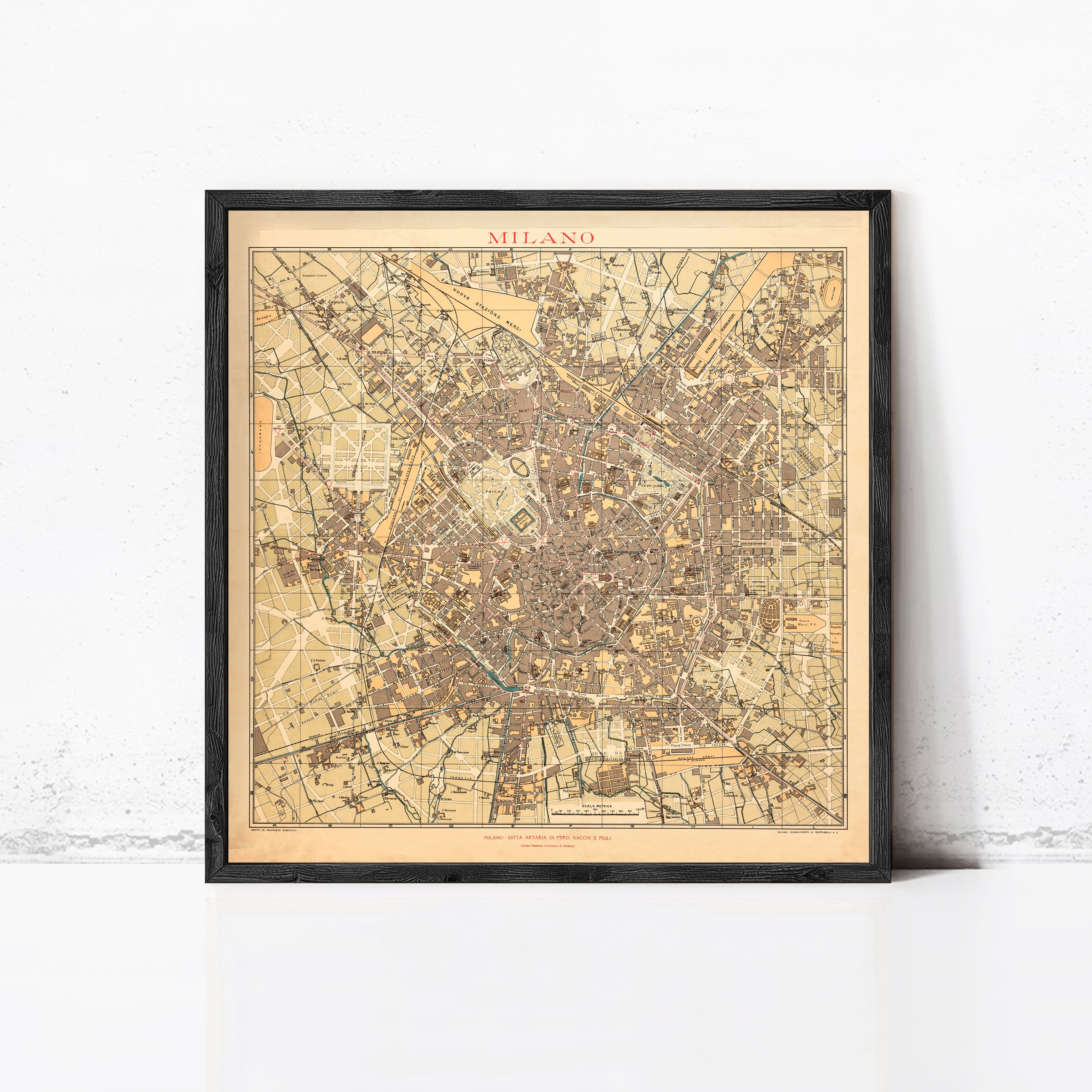 The image is a framed vintage map of Milan, Italy, depicting the city's layout and streets.