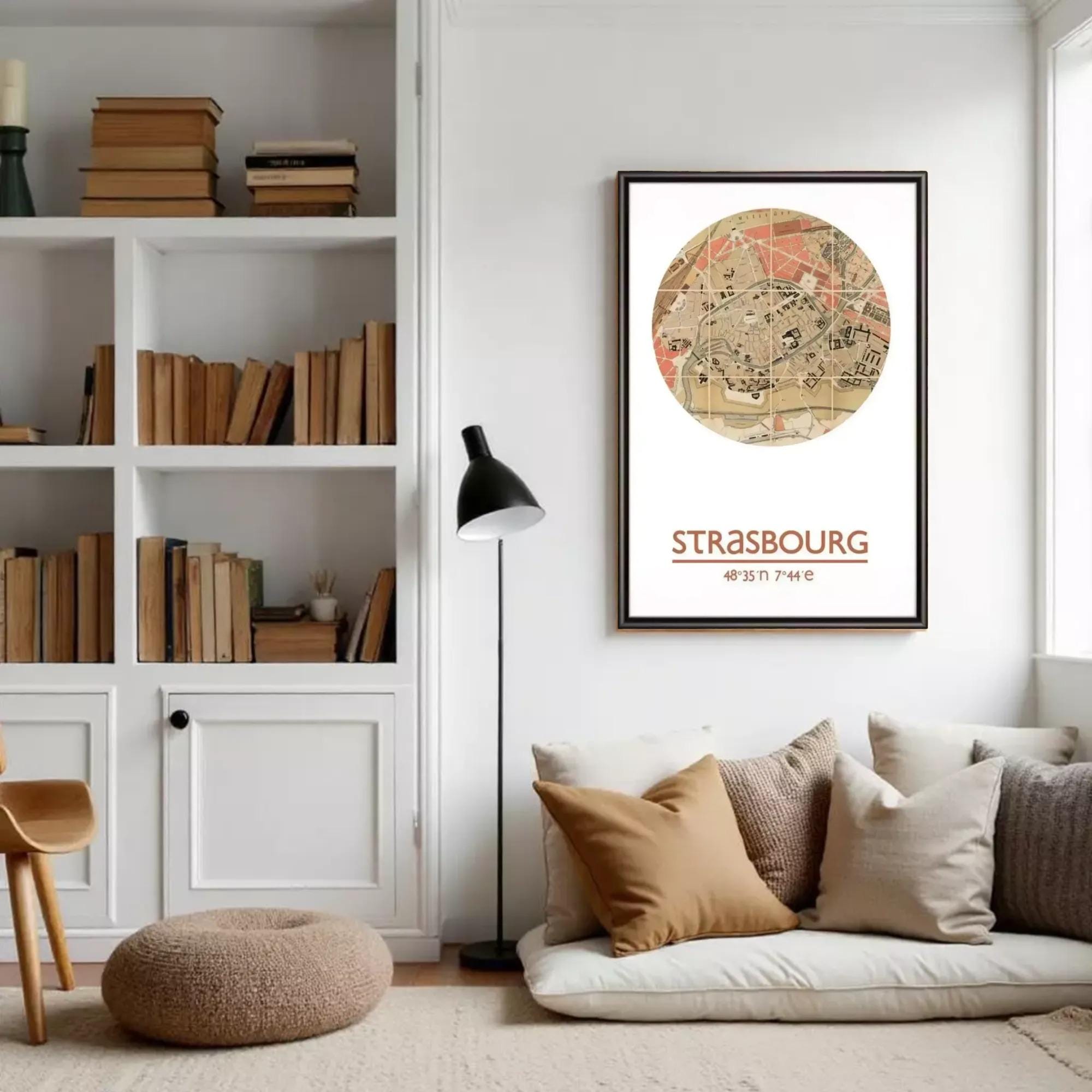 a cozy living room with a bookshelf filled with books, a comfortable sofa with pillows, and a floor lamp. A framed map of Strasbourg, France, is displayed on the wall, and the text "Strasbourg" is visible.