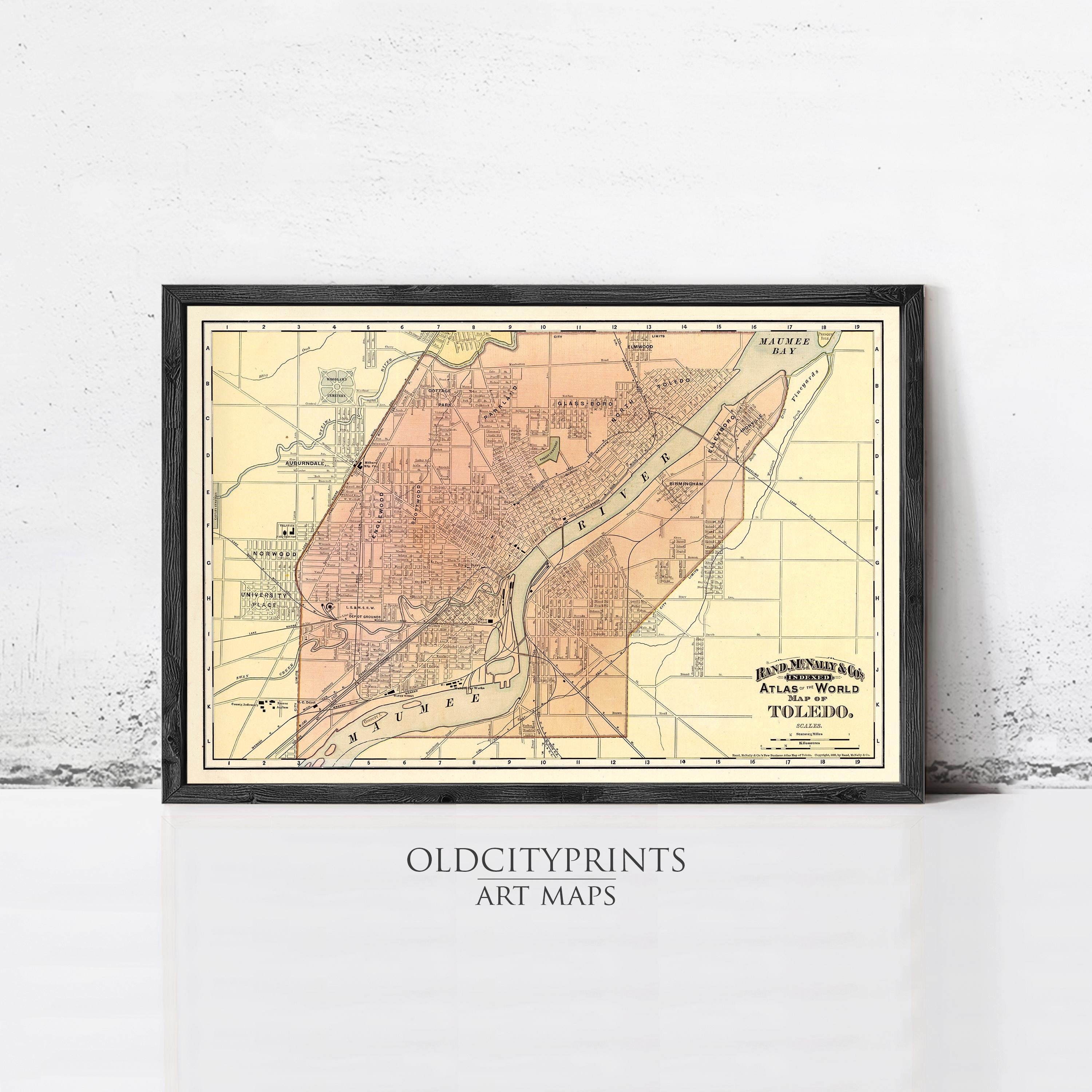 The image is a framed vintage map of a city, likely Toledo, Ohio, with a black border and a yellow and orange color scheme.