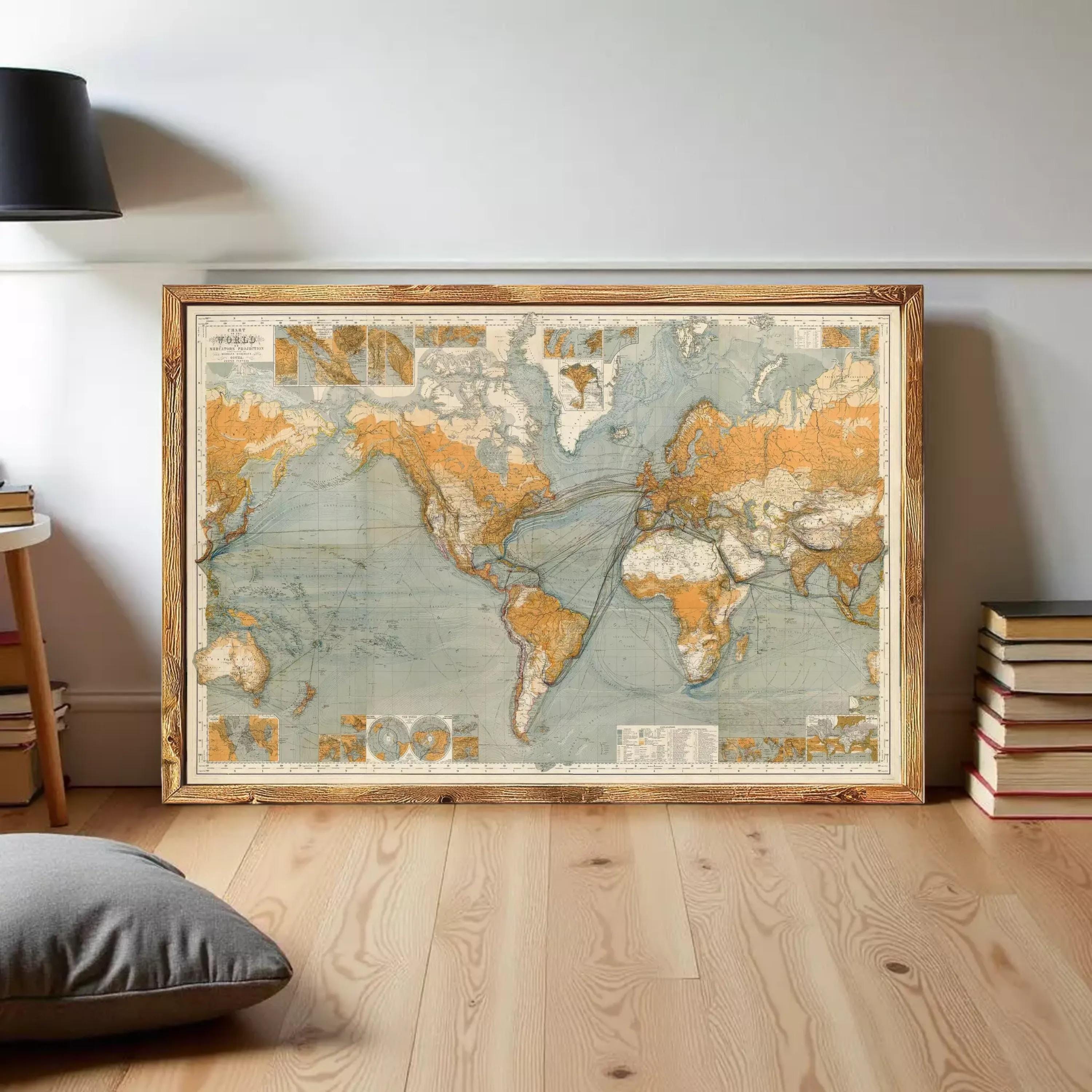 The image is a framed vintage world map with a wooden border, displayed on a white wall.