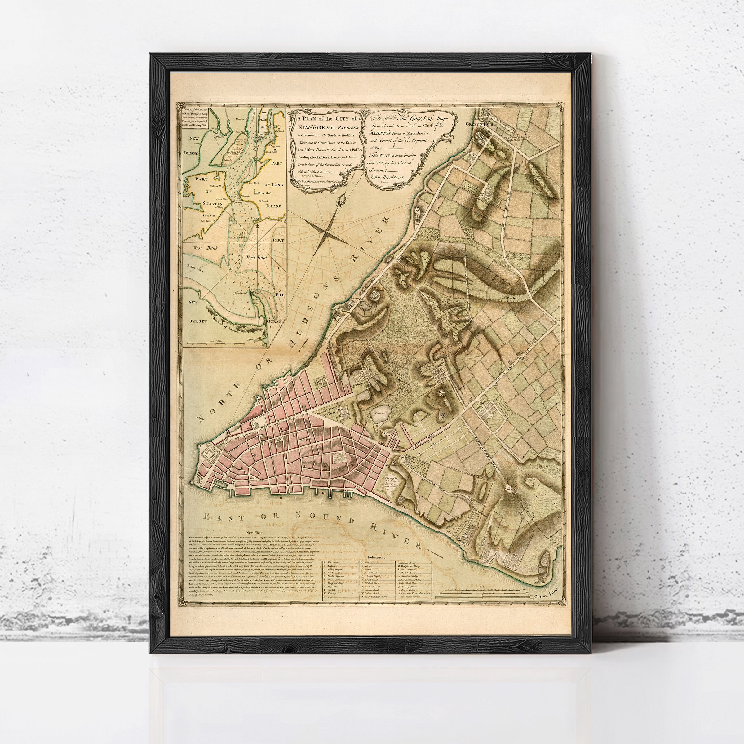 The image is a framed historical map of the city of New York, depicting the city's layout and surrounding areas.
