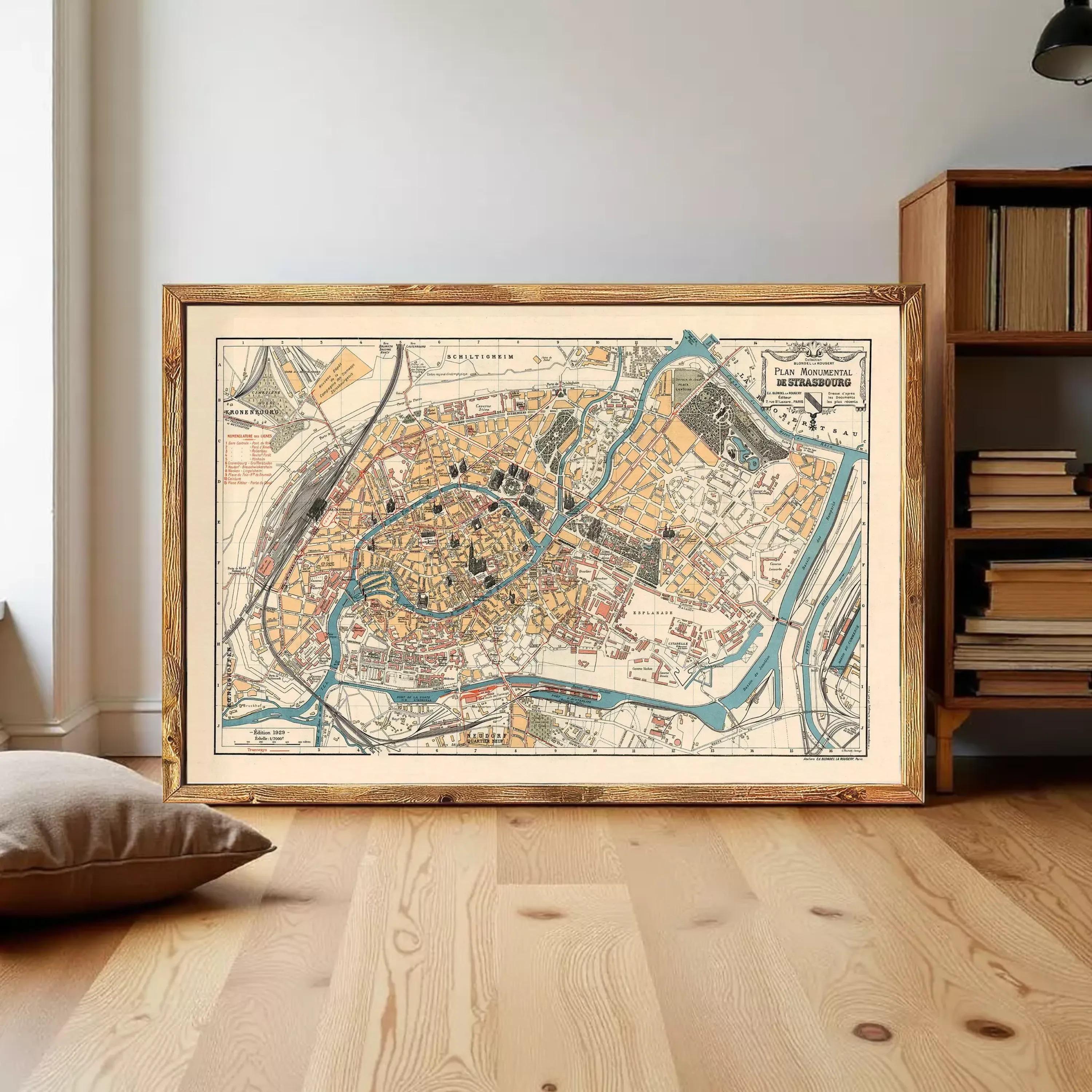 The image is a framed vintage map of a city, depicting various landmarks and streets in a detailed and colorful manner.
