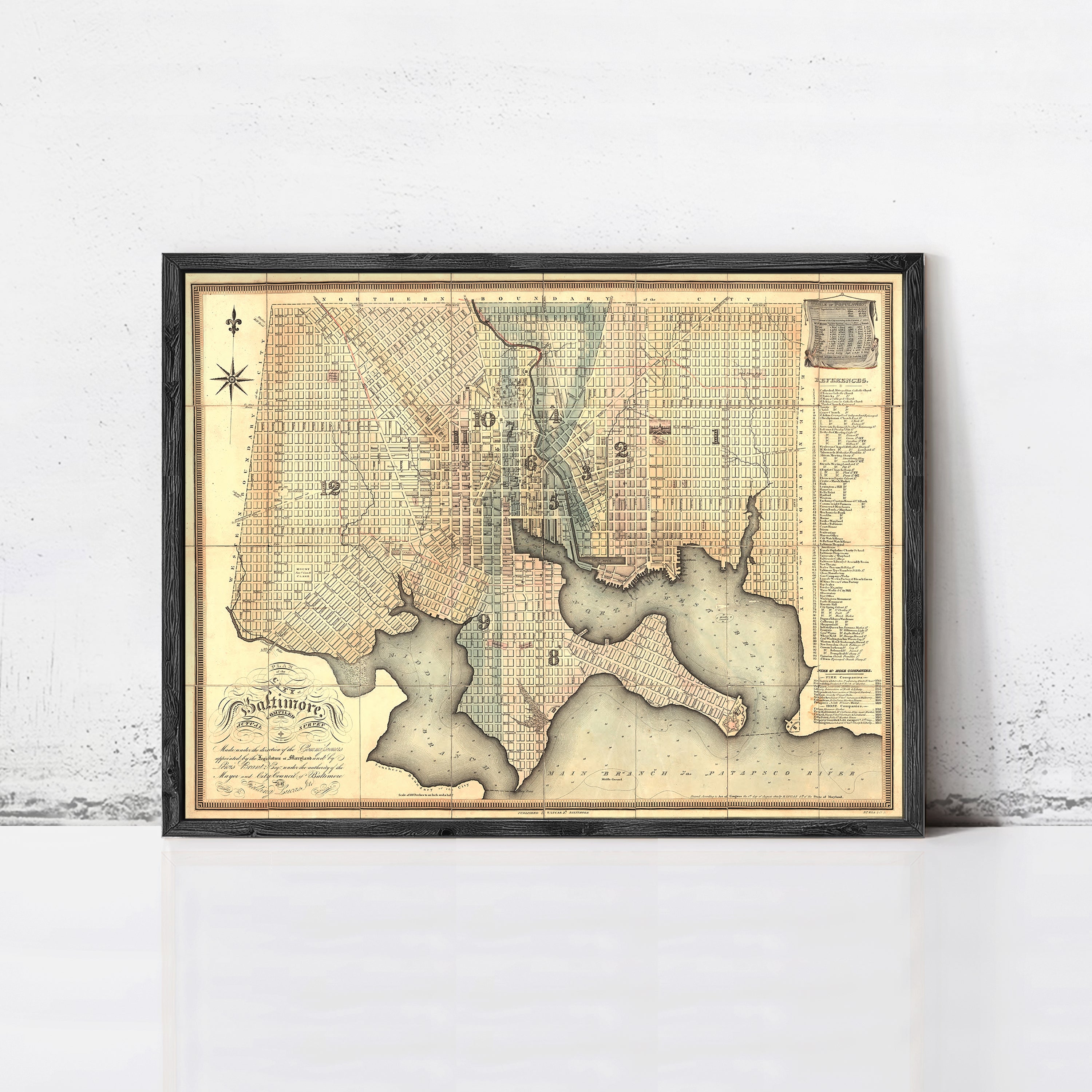 The image is a framed antique map of a city, likely Washington, D.C., with detailed cartography and geographical information.