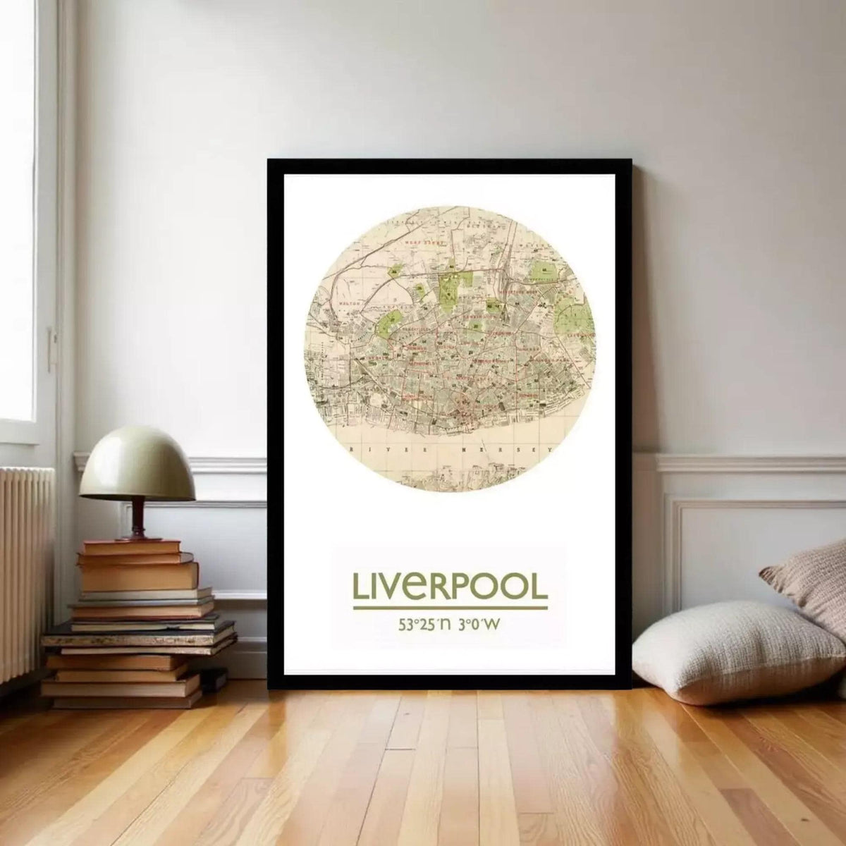 a framed map of Liverpool, with a lamp and books on a shelf in the background.