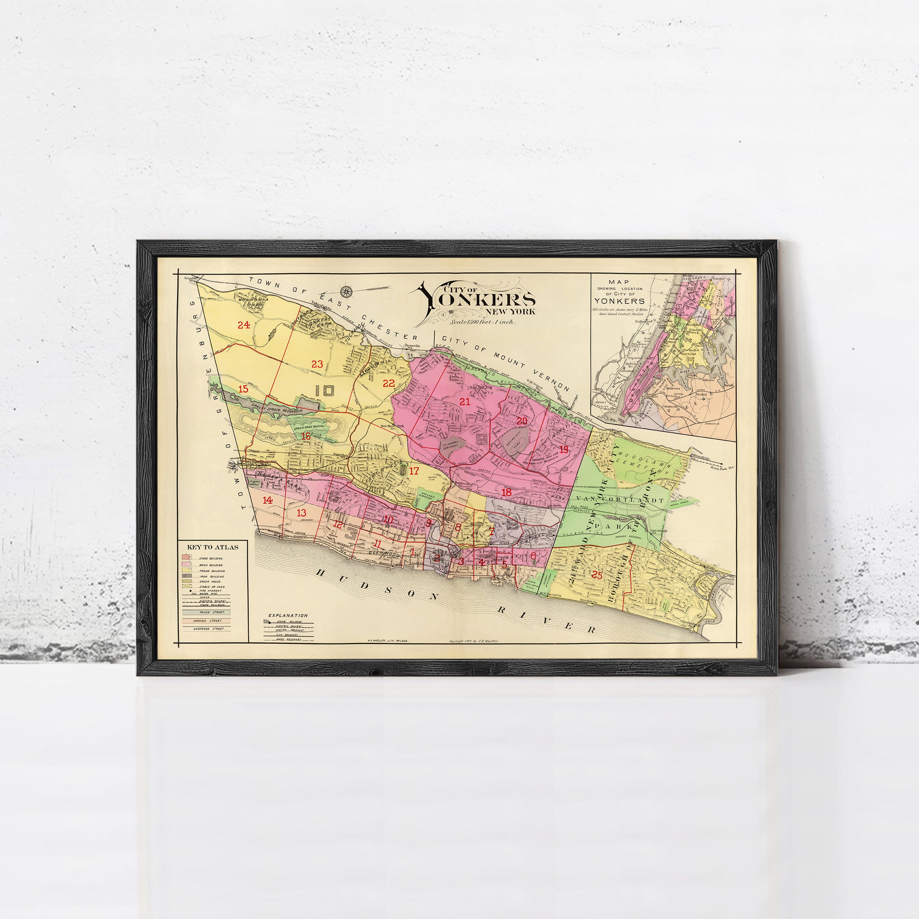 The image is a framed vintage map of New York, depicting the city in a colorful and detailed manner.
