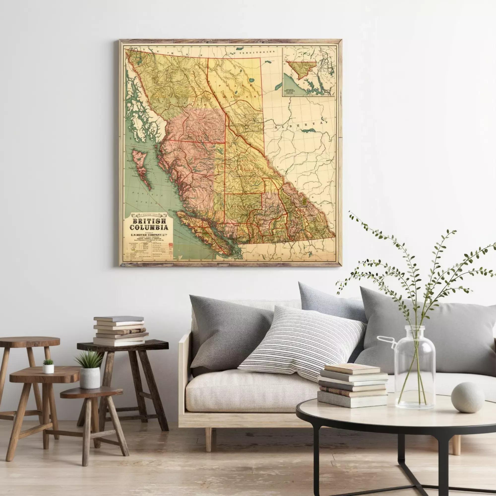 a large framed map of British Columbia, Canada, hanging on a wall above a couch and a coffee table in a living room setting.