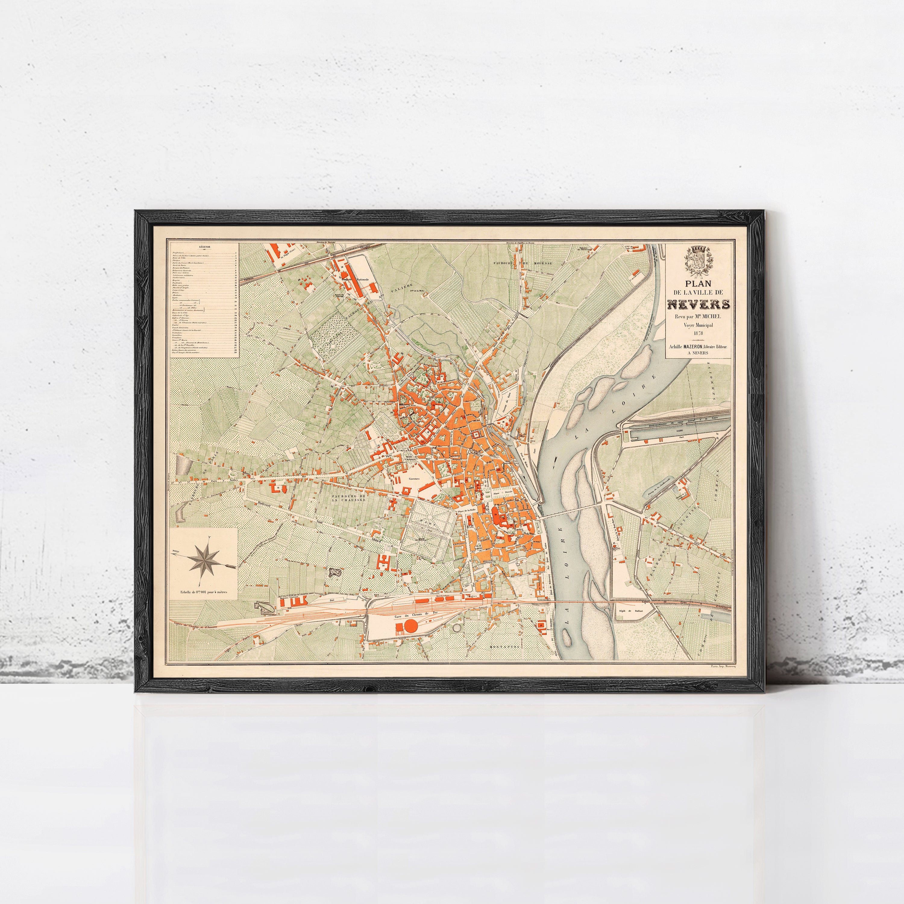 The image is a framed vintage map of the town of Nevers, France, depicting the layout of the streets and surrounding areas.