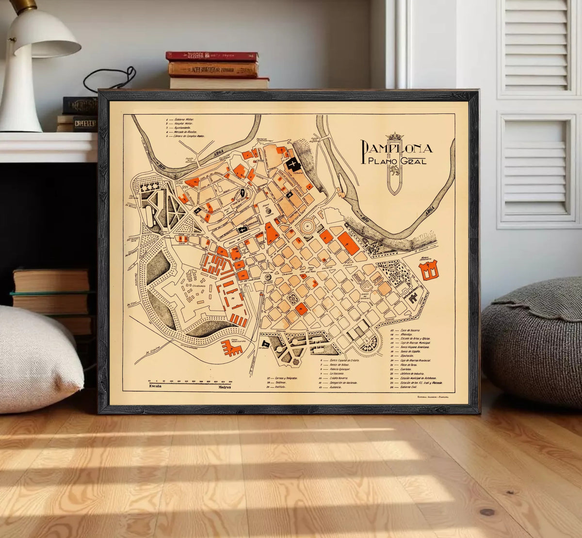 The image is a framed map of the city of Pamplona, Spain, depicting the layout and various landmarks within the city.