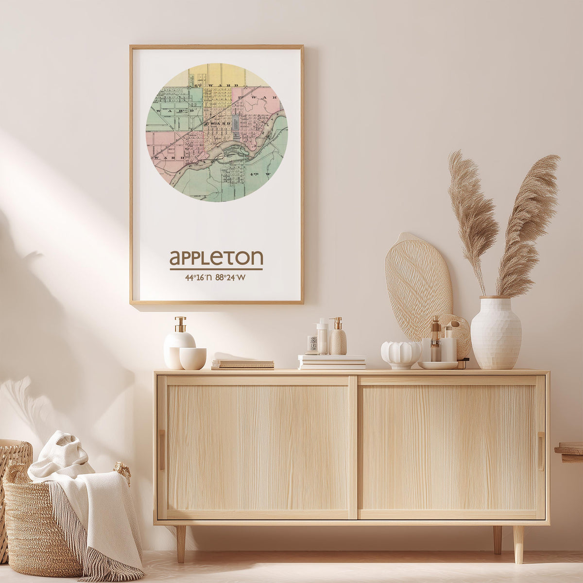 a framed map of Appleton, Wisconsin, hanging on a wall above a wooden cabinet. The cabinet has various items on it, including a vase with pampas grass, a bottle, and a book.