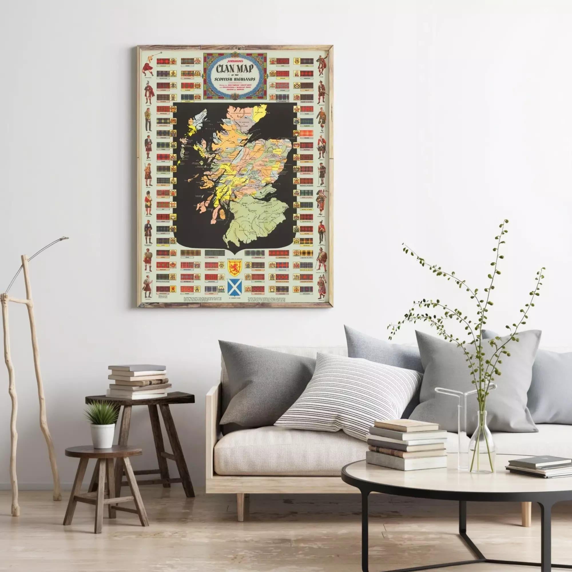 a living room with a large framed map of Scotland hanging on the wall. The room has a couch, a coffee table, and some books and decorative items on the table.