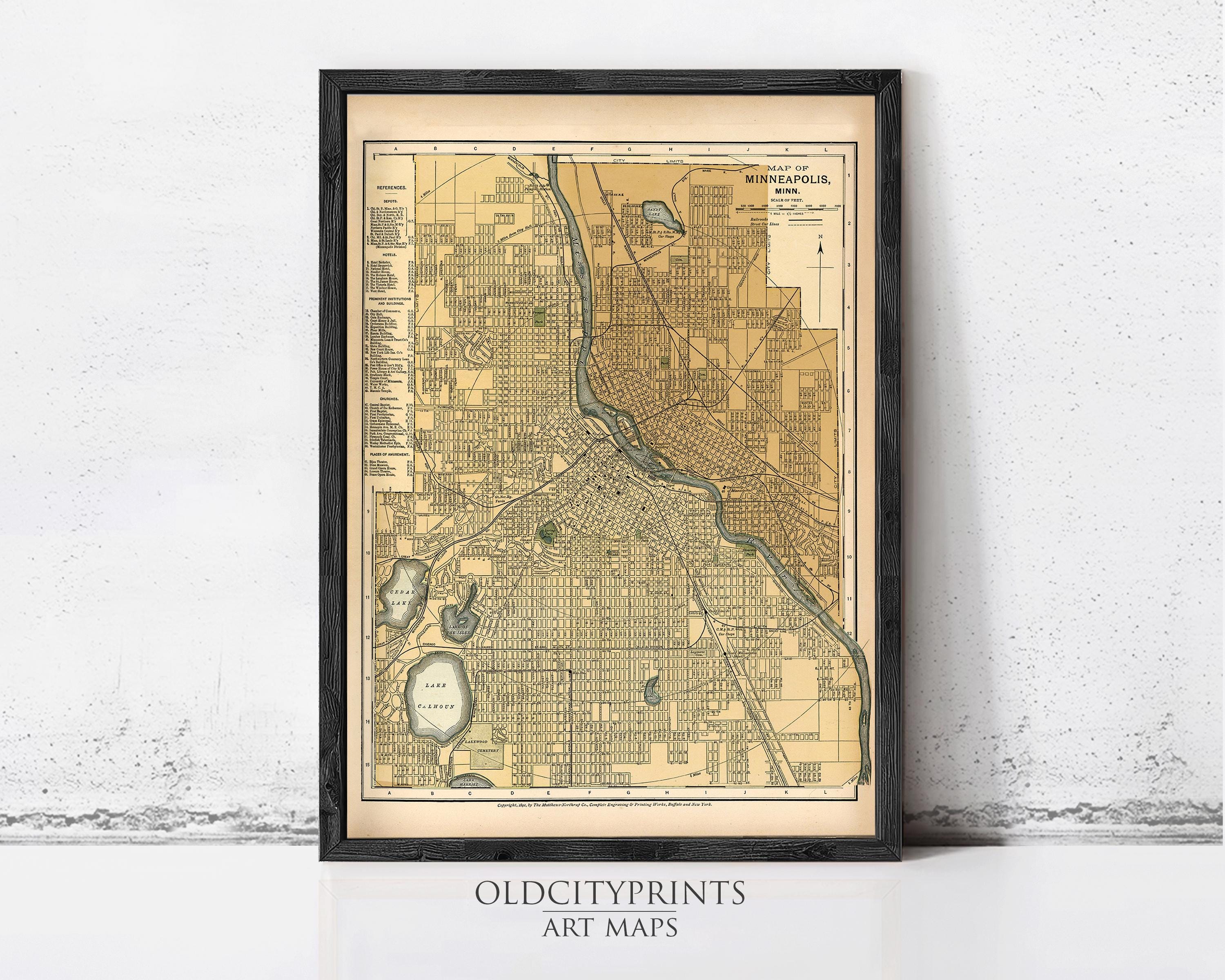The image is a framed vintage map of Minneapolis, Minnesota, with a black border and a beige background.