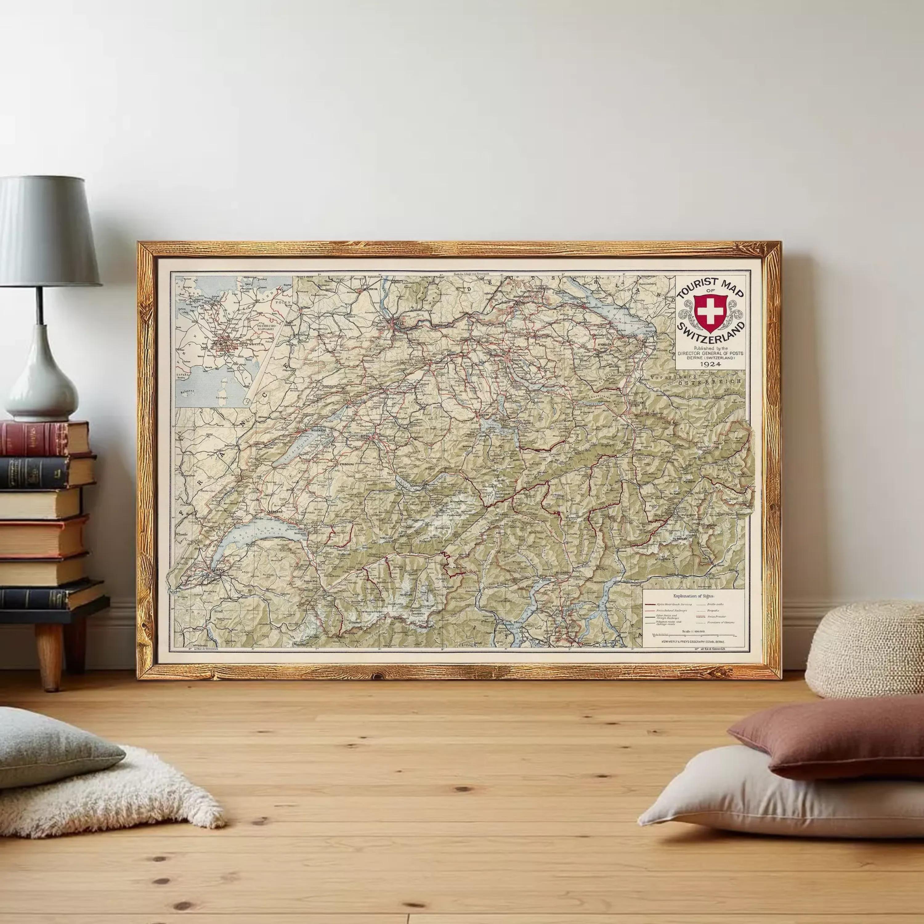 The image is a framed map of Switzerland, with a Swiss flag and a red cross symbol on the top right corner.