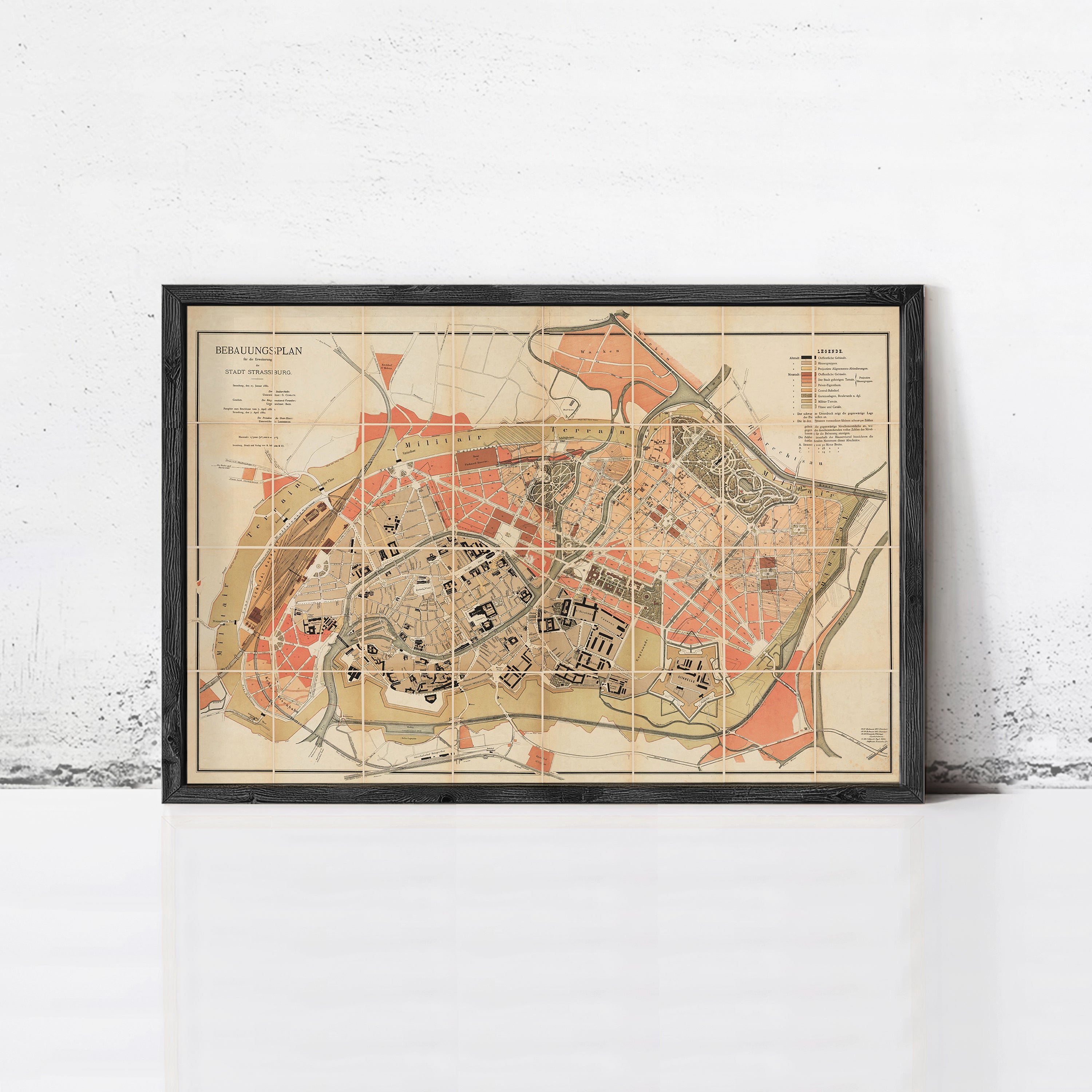 The image is a framed map of a city, showing various streets, buildings, and other urban features.