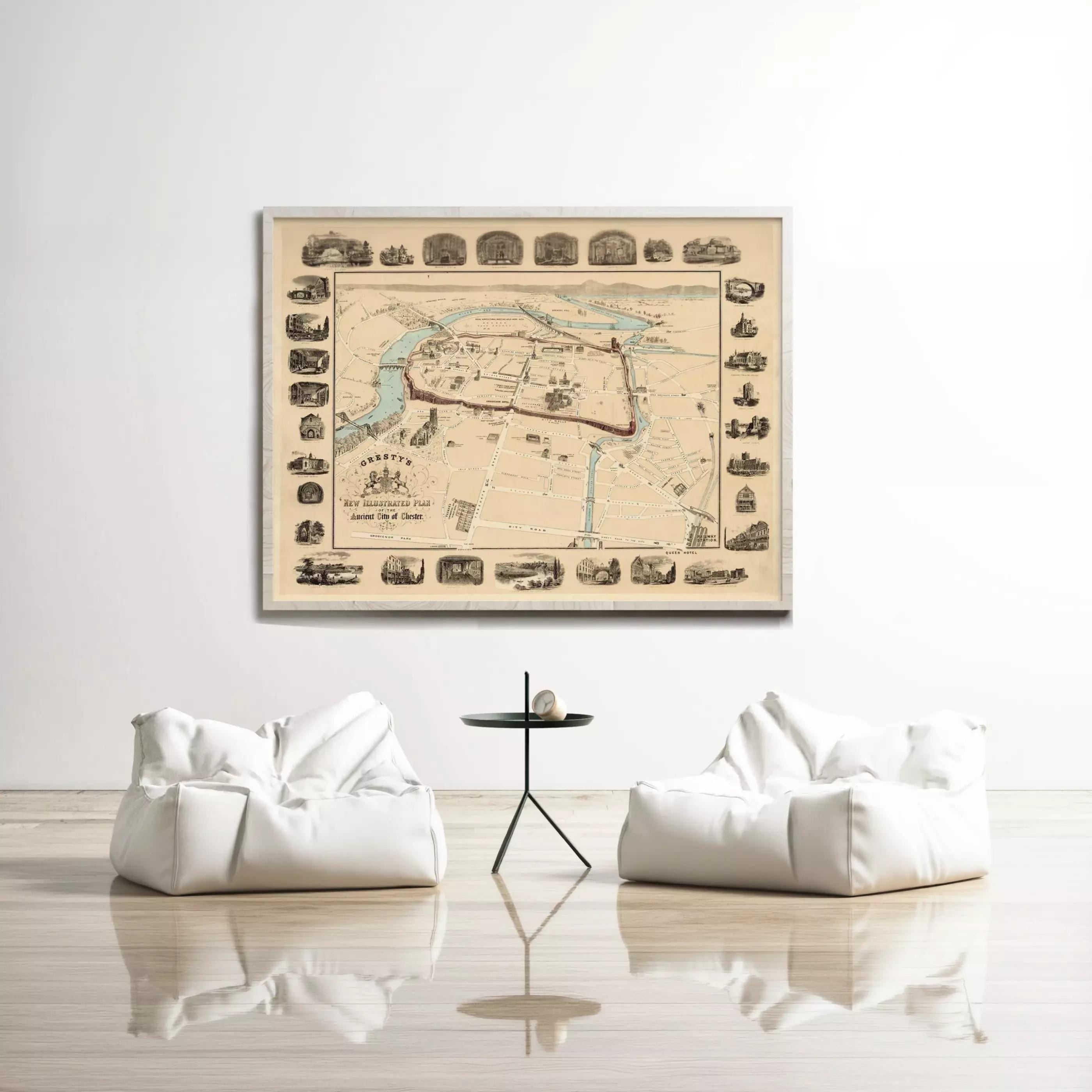 a large framed map hanging on a white wall, with two white bean bag chairs positioned in front of it.