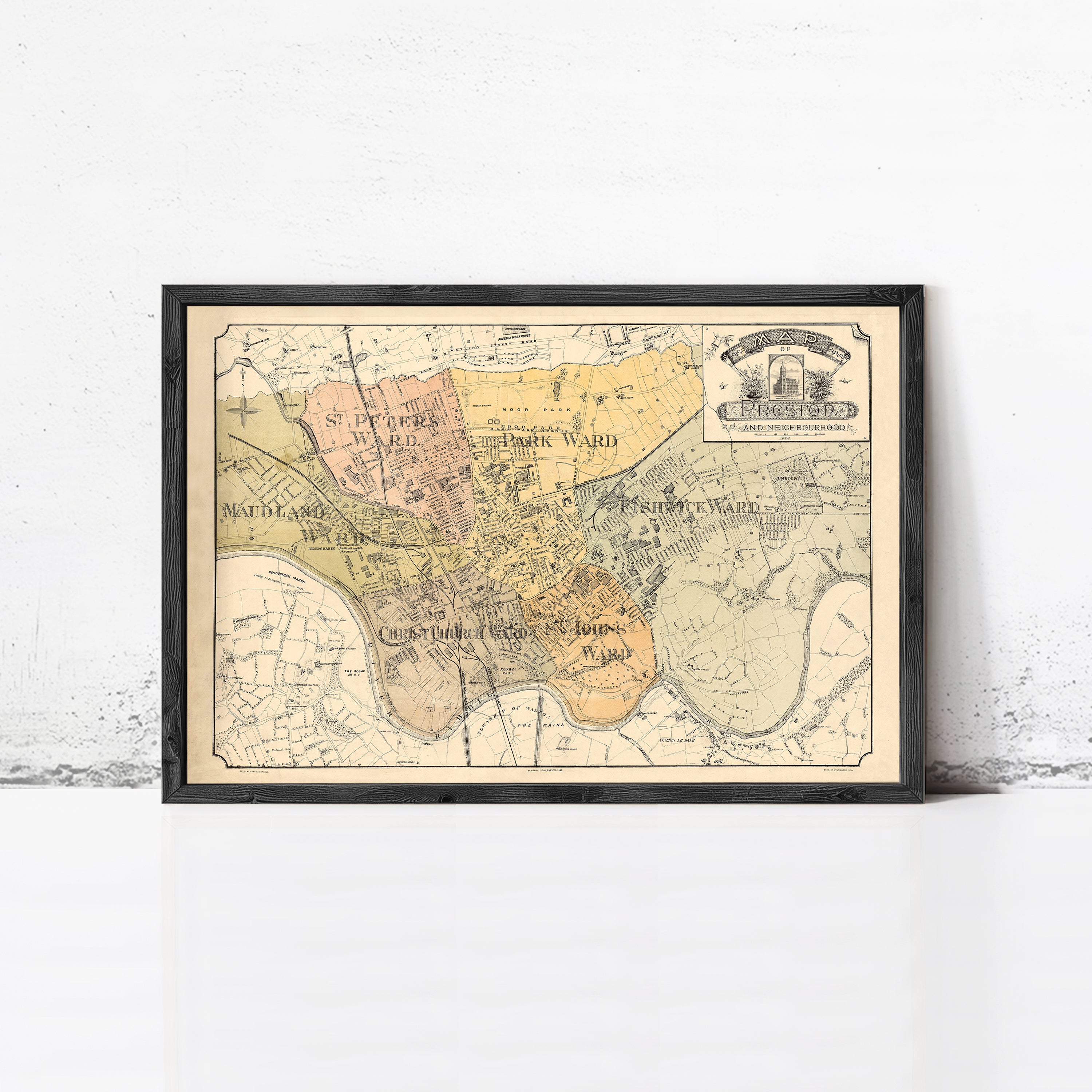The image is a framed vintage map of a city, depicting various landmarks and streets.
