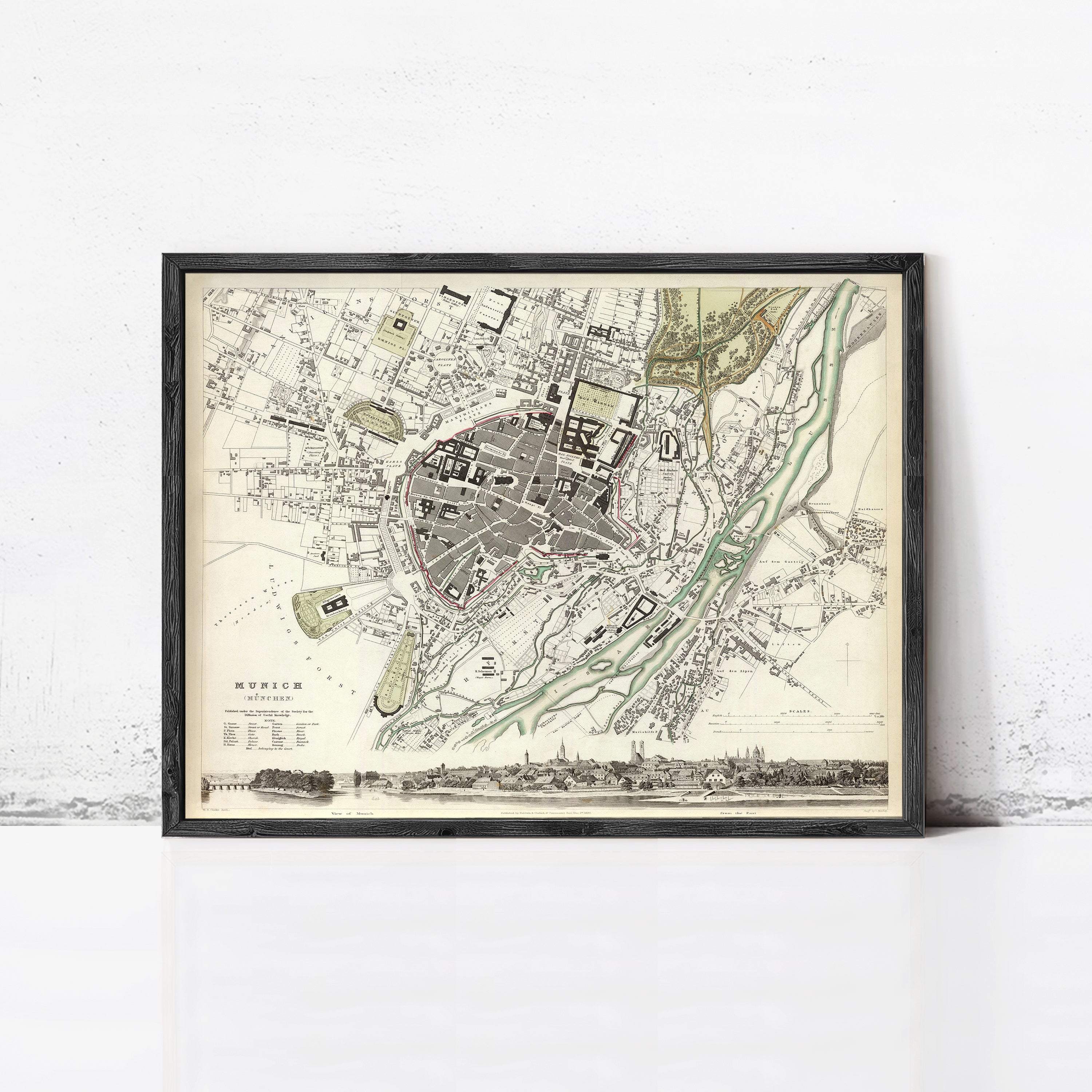 The image is a framed vintage map of a city, depicting a detailed layout of streets, buildings, and other urban features.