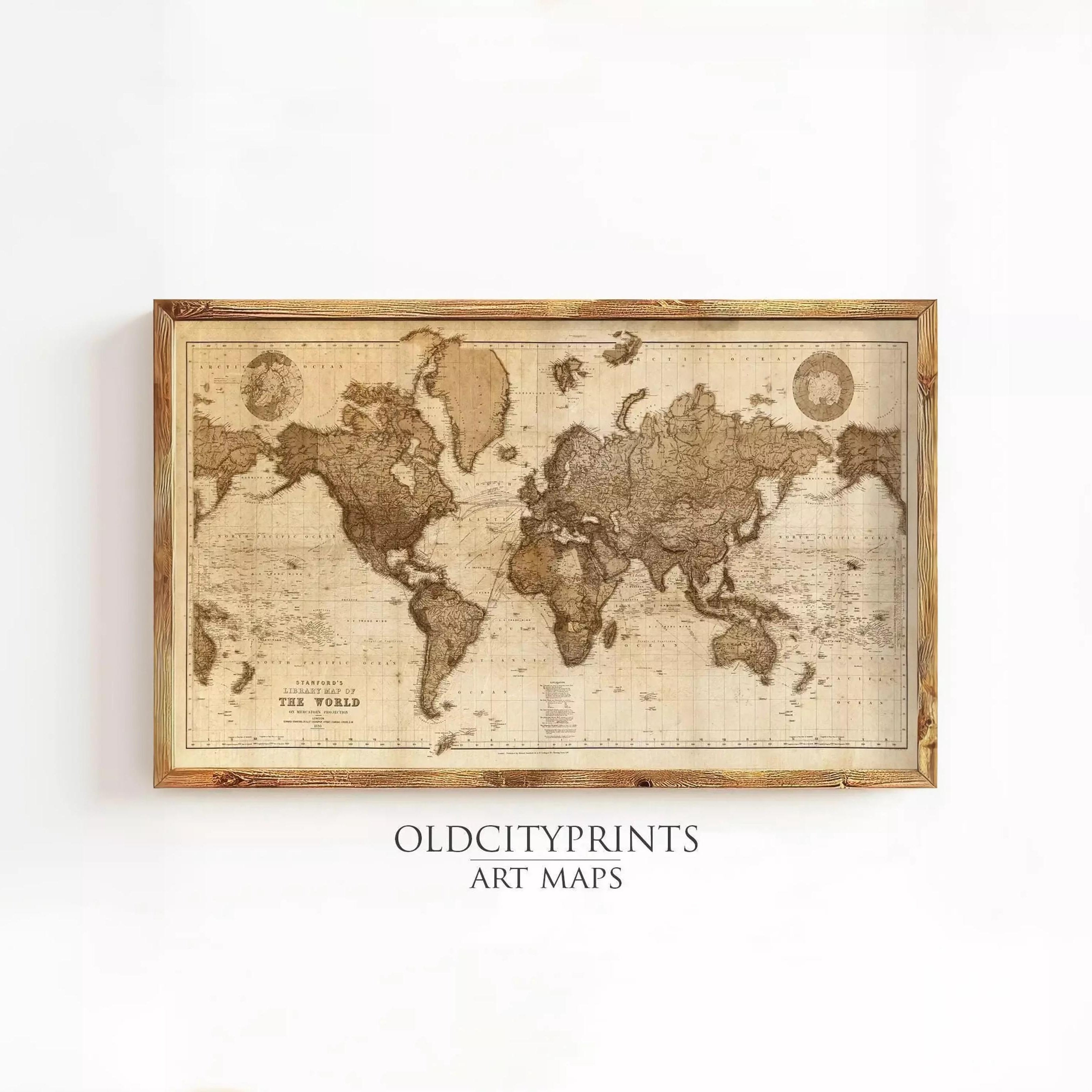 The image is a framed vintage world map with a wooden border, displayed on a white wall.