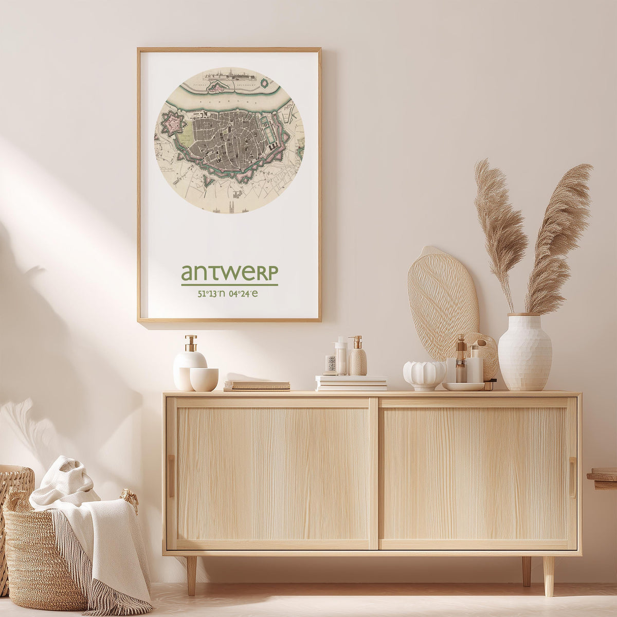 a wooden cabinet with a framed map of Antwerp, a city in Belgium, hanging on the wall above it. The cabinet is situated in a room with a beige color scheme, and there are decorative elements such as a potted plant, a vase, and a book on the cabinet.