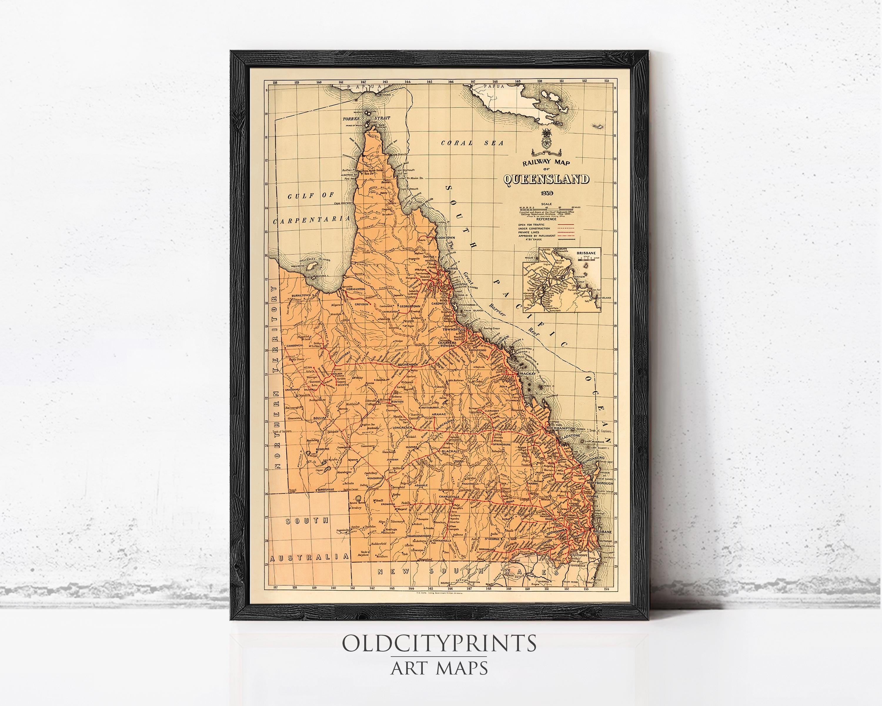The image is a framed vintage map of the Queensland region in Australia, depicting the state's geographical layout and boundaries.