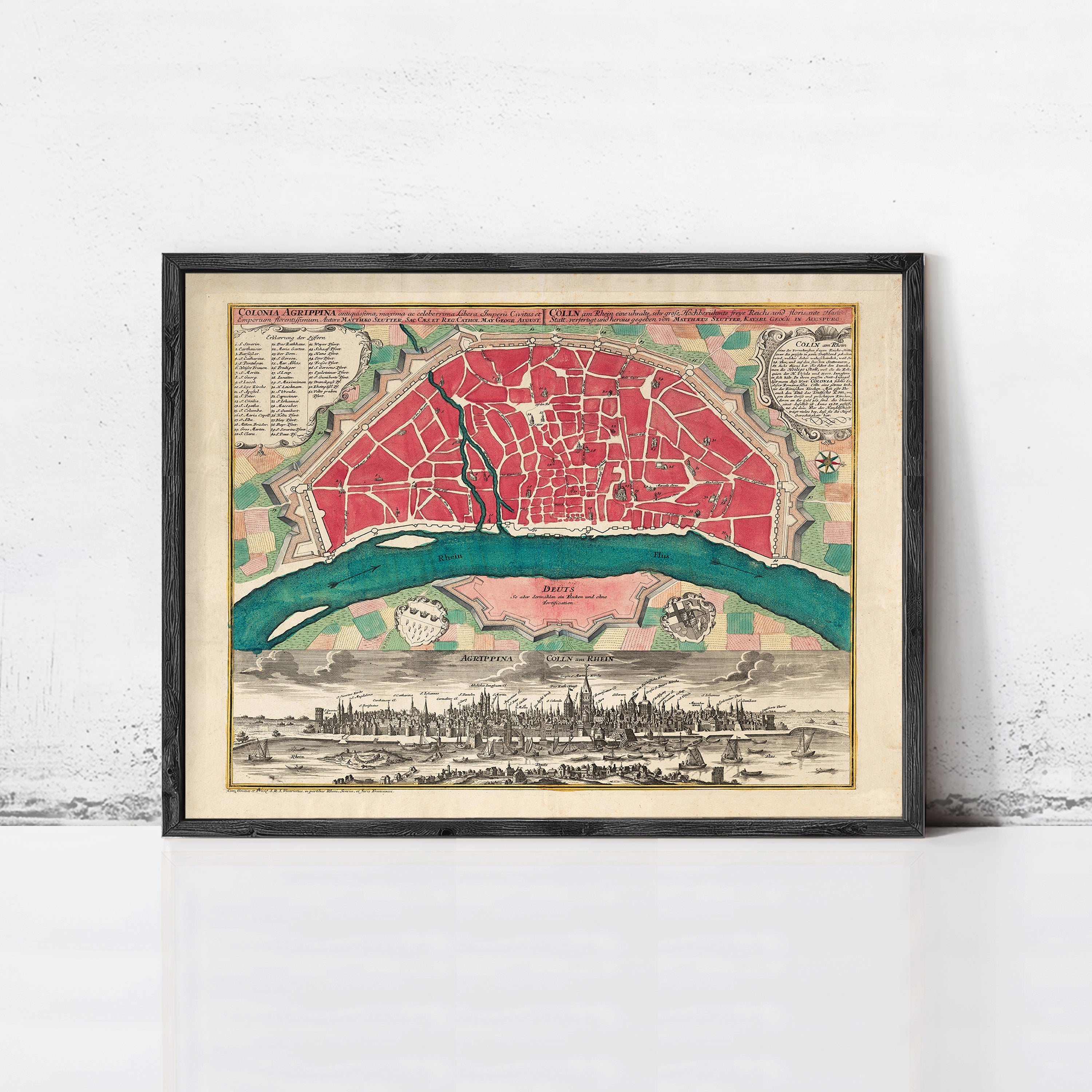 The image is a framed vintage map of a city, depicting a detailed layout of the city's streets, landmarks, and surrounding areas.