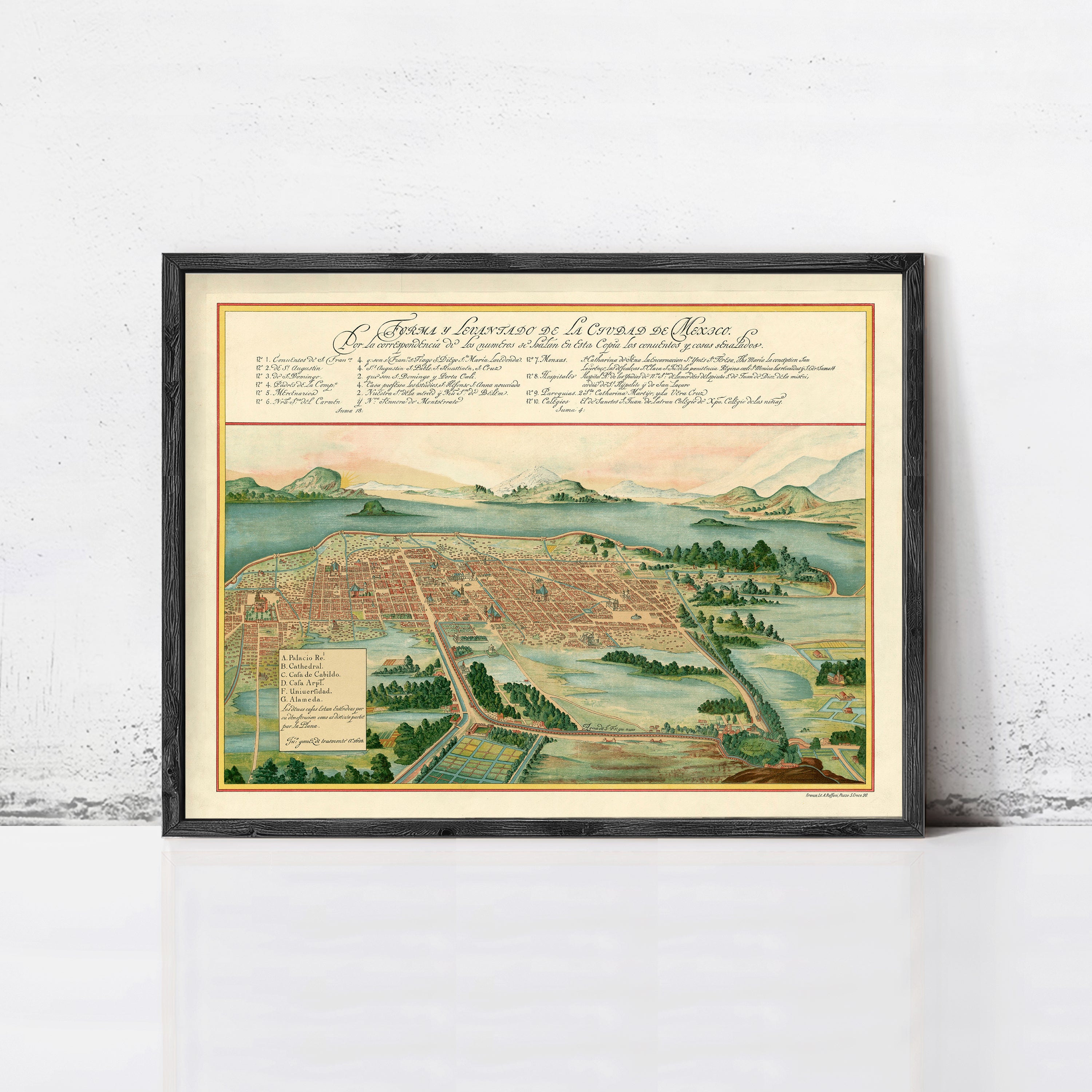 The image is a framed historical map of Mexico, depicting a city surrounded by mountains and lush greenery.