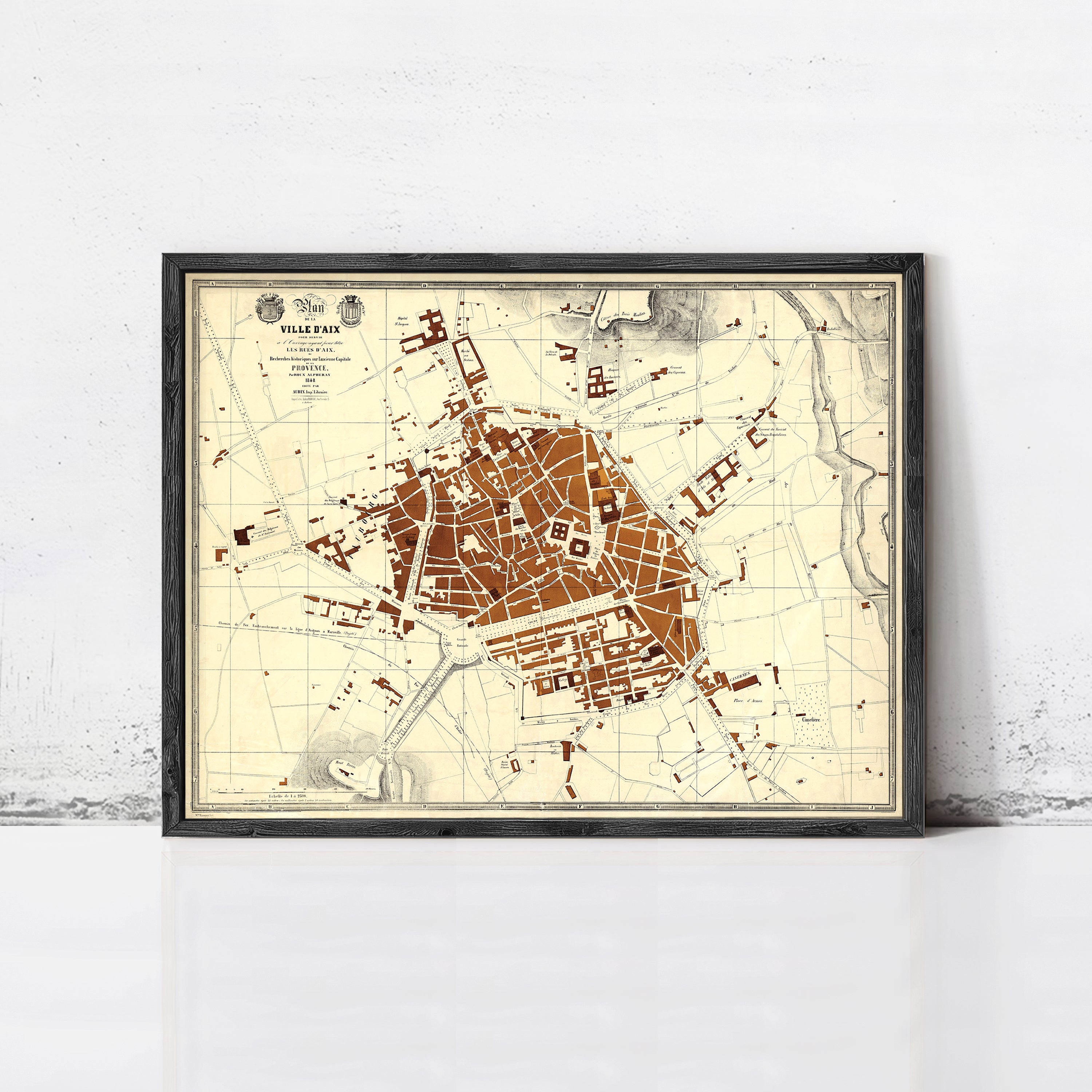 The image is a framed map of a city, likely a historical or vintage map, displayed on a wall.