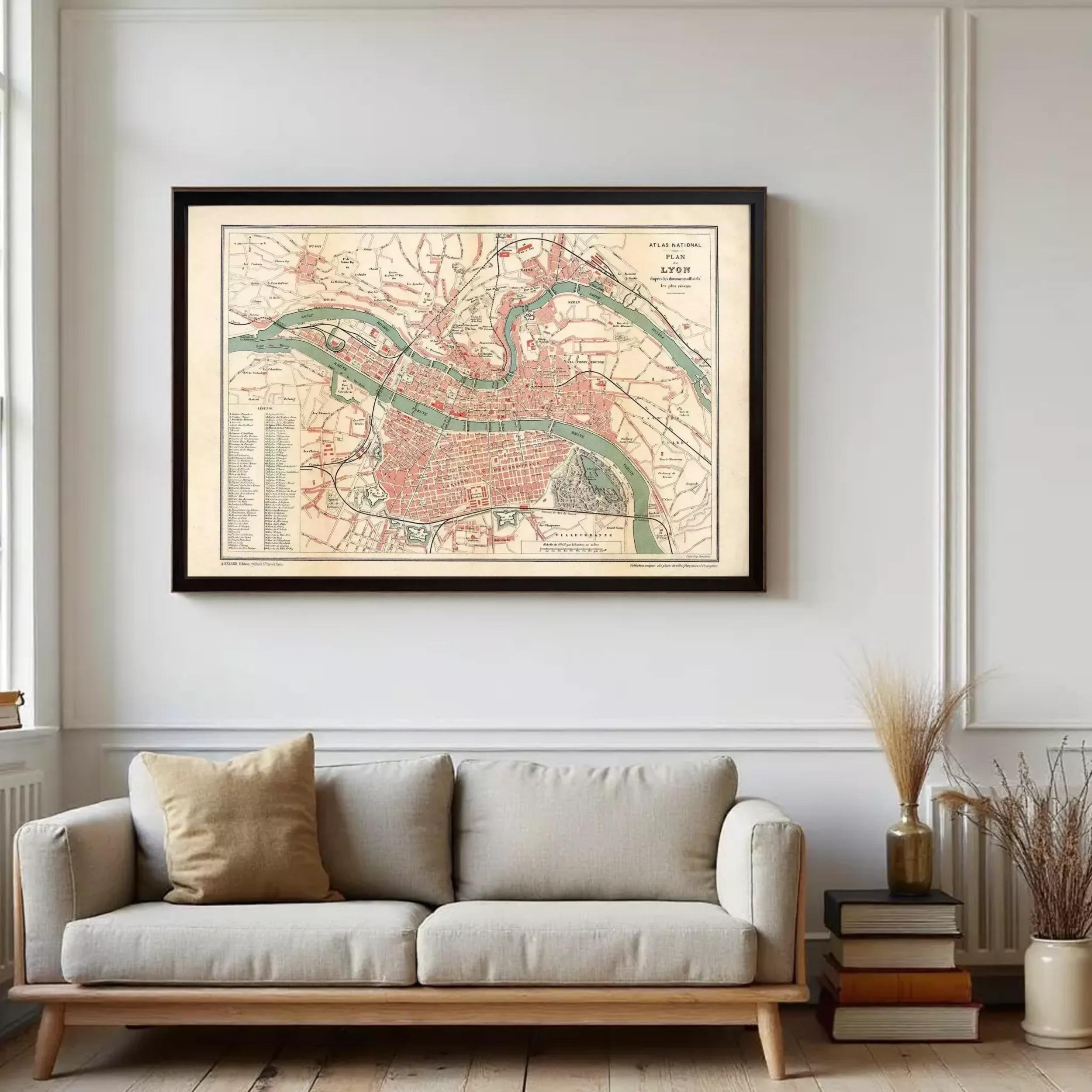 a large framed map of a city hanging on a wall above a gray sofa in a living room.