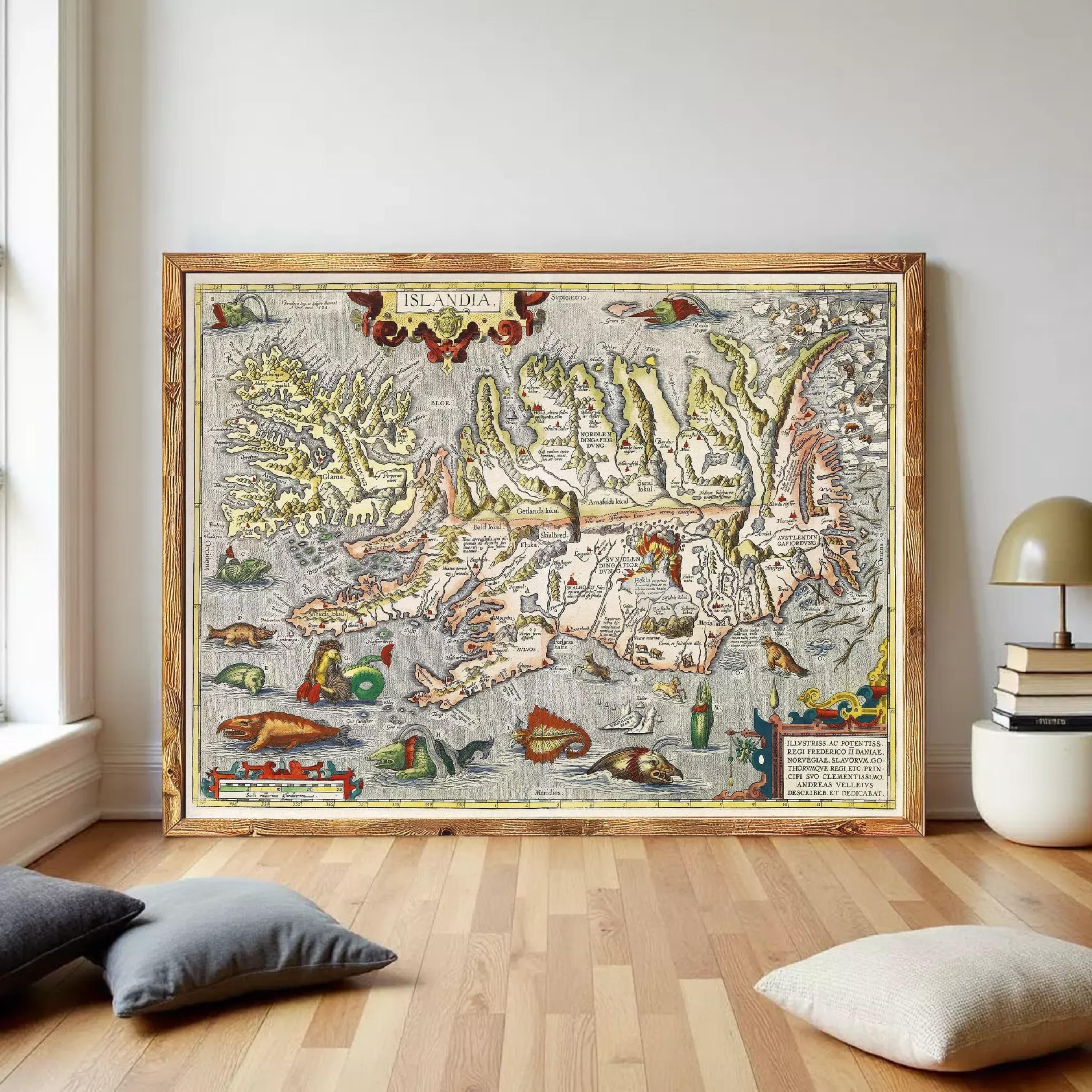 a large, ornate map of Iceland, with intricate details and illustrations, displayed on a wooden floor in a room with a lamp and some pillows.