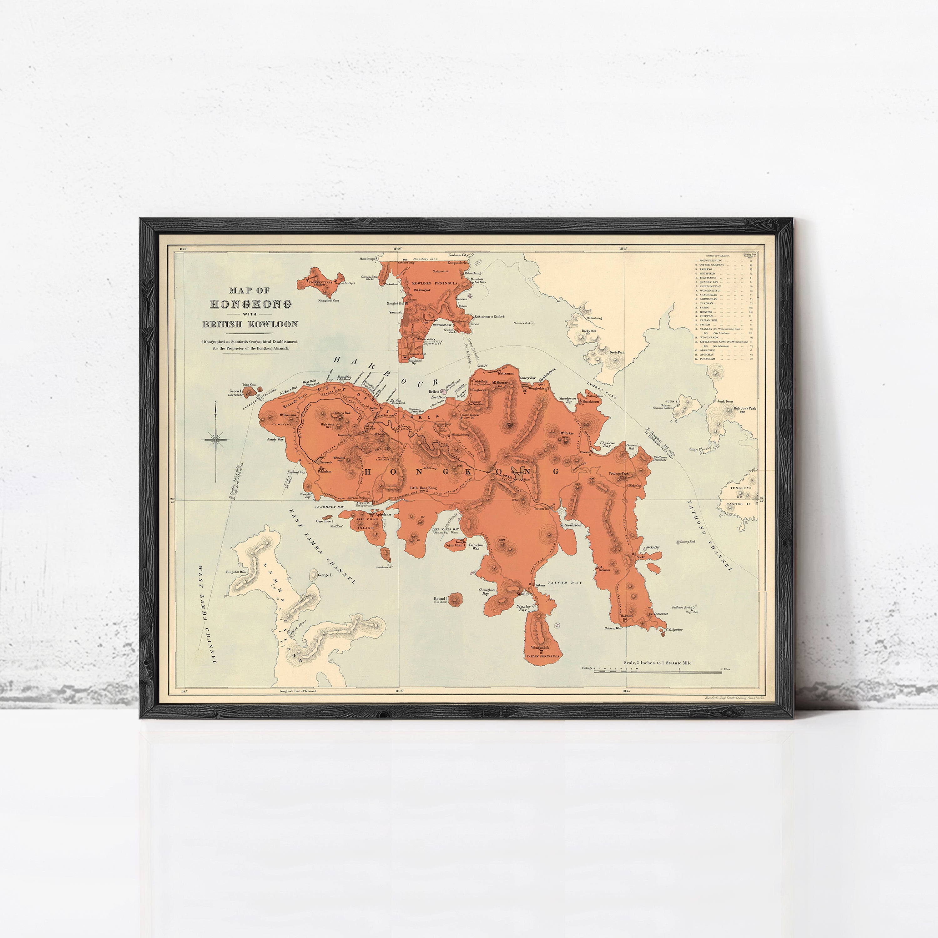 The image is a framed vintage map of Hong Kong, depicting the island and surrounding areas in a detailed and colorful manner.