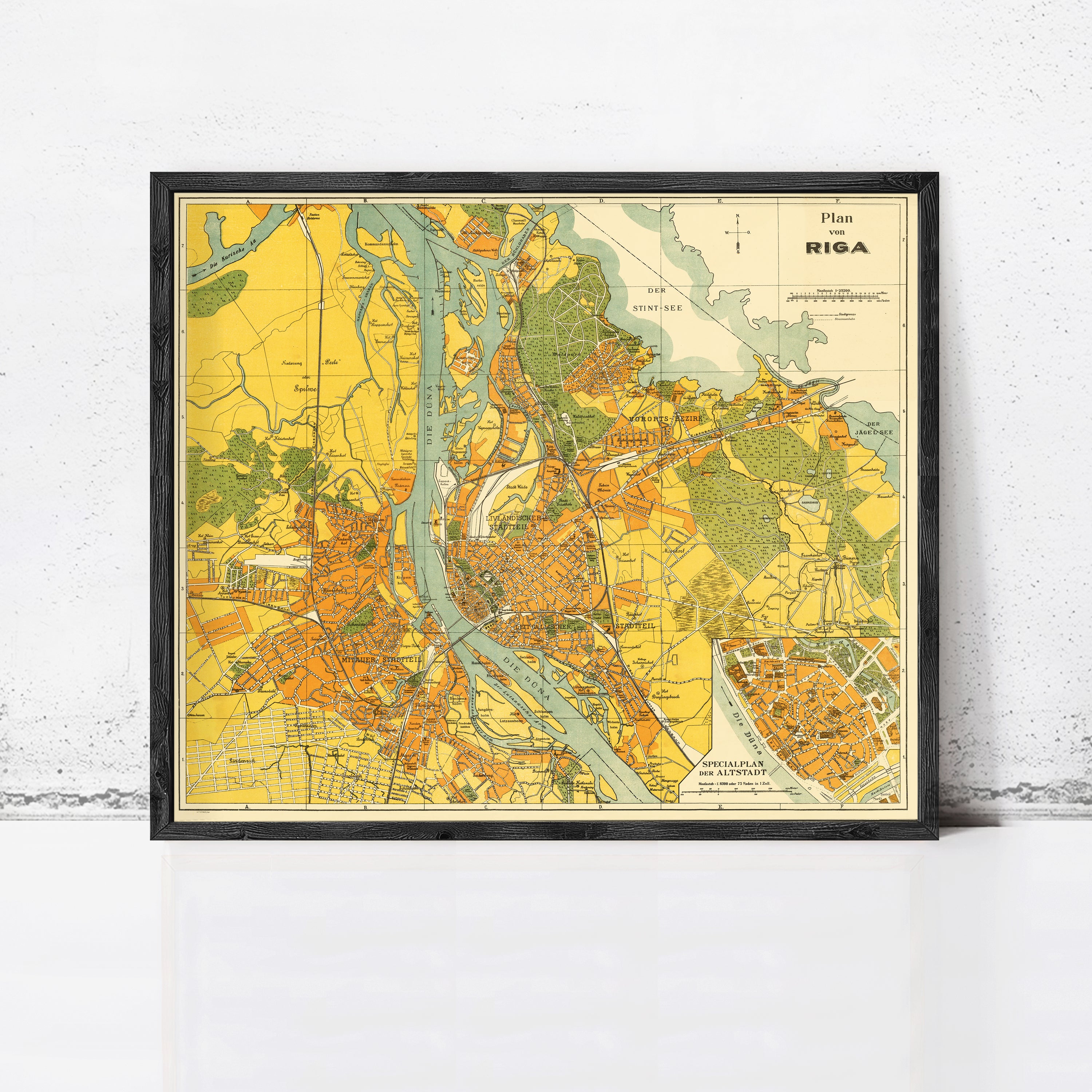The image is a framed vintage map of Riga, Latvia, depicting the city and surrounding areas in a detailed and colorful manner.