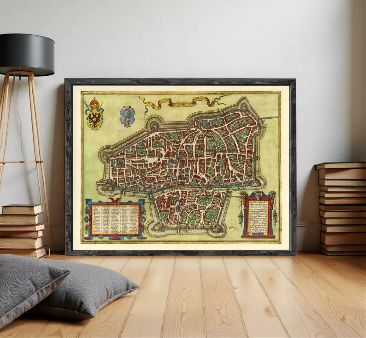 The image is a framed antique map of a city, likely from the Middle Ages, with intricate details and a decorative border.
