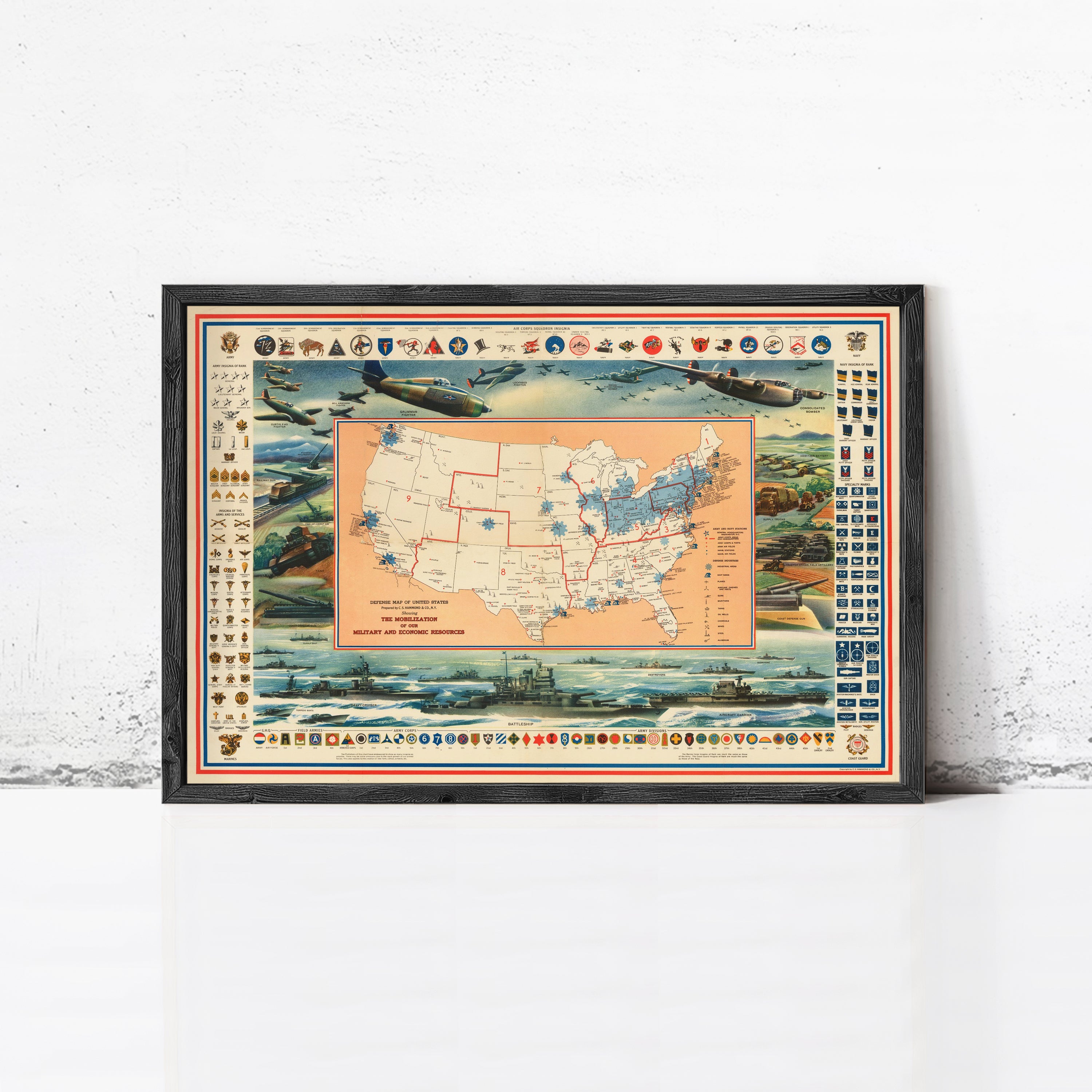 The image is a framed vintage map of the United States, depicting various military and economic symbols and locations.