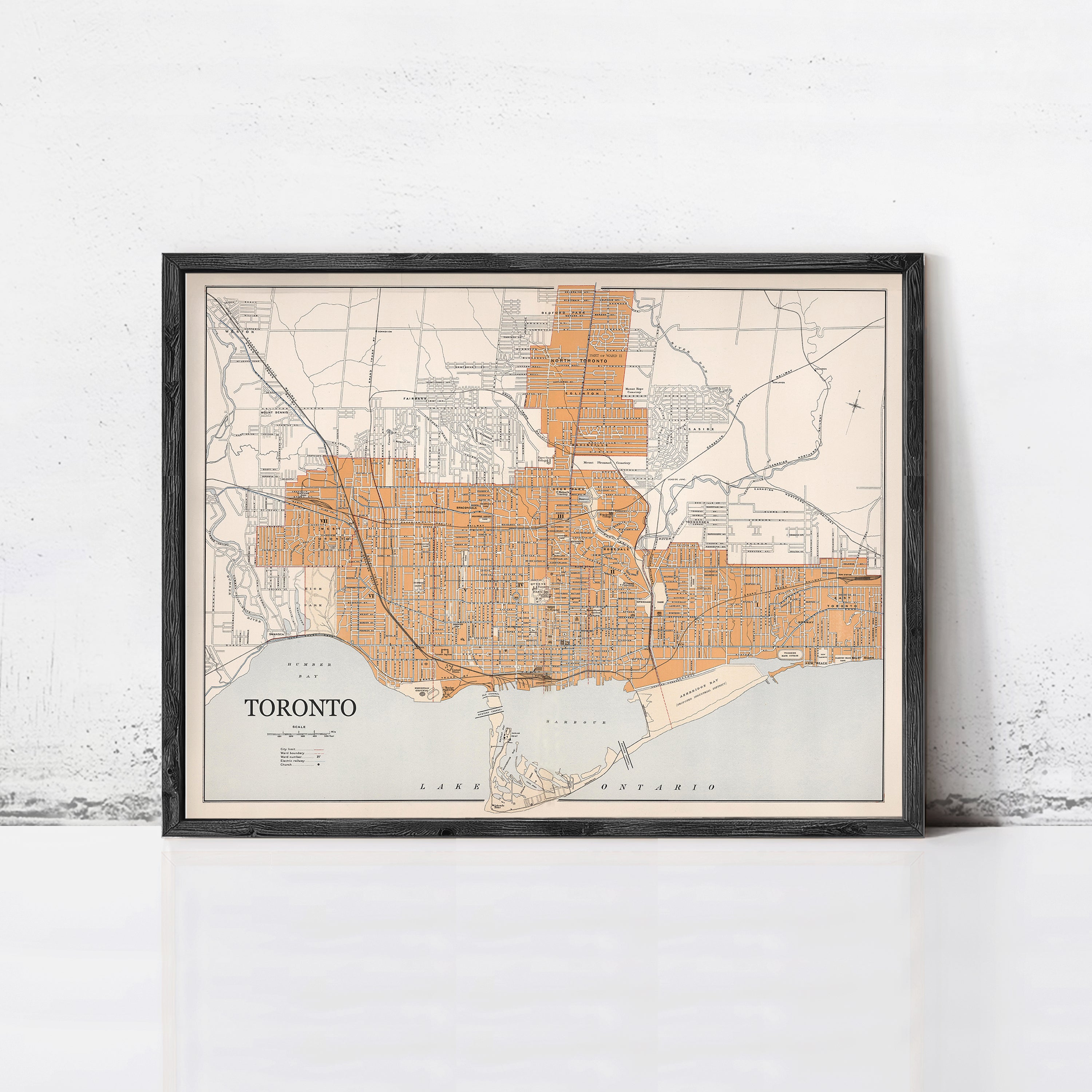 The image is a framed map of Toronto, Canada, depicting the city's streets and surrounding areas.